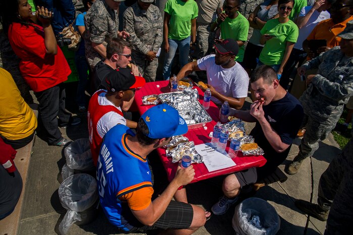 Contestants face off  during the Dorm Tailgate Party Hot Dog Eating contest May 10, 2013, at Joint Base Charleston – Air Base, S.C. The Tailgate Party was designed to strengthen social ties among dorm members and enhance their esprit de corps. The party was sponsored by the Single Airman's Initiative Program and the Air Force Sergeants Association, and included a dirty truck competition, a hot dog eating contest, a basketball tournament and a live DJ.  (U.S. Air Force photo/ Senior Airman George Goslin)
