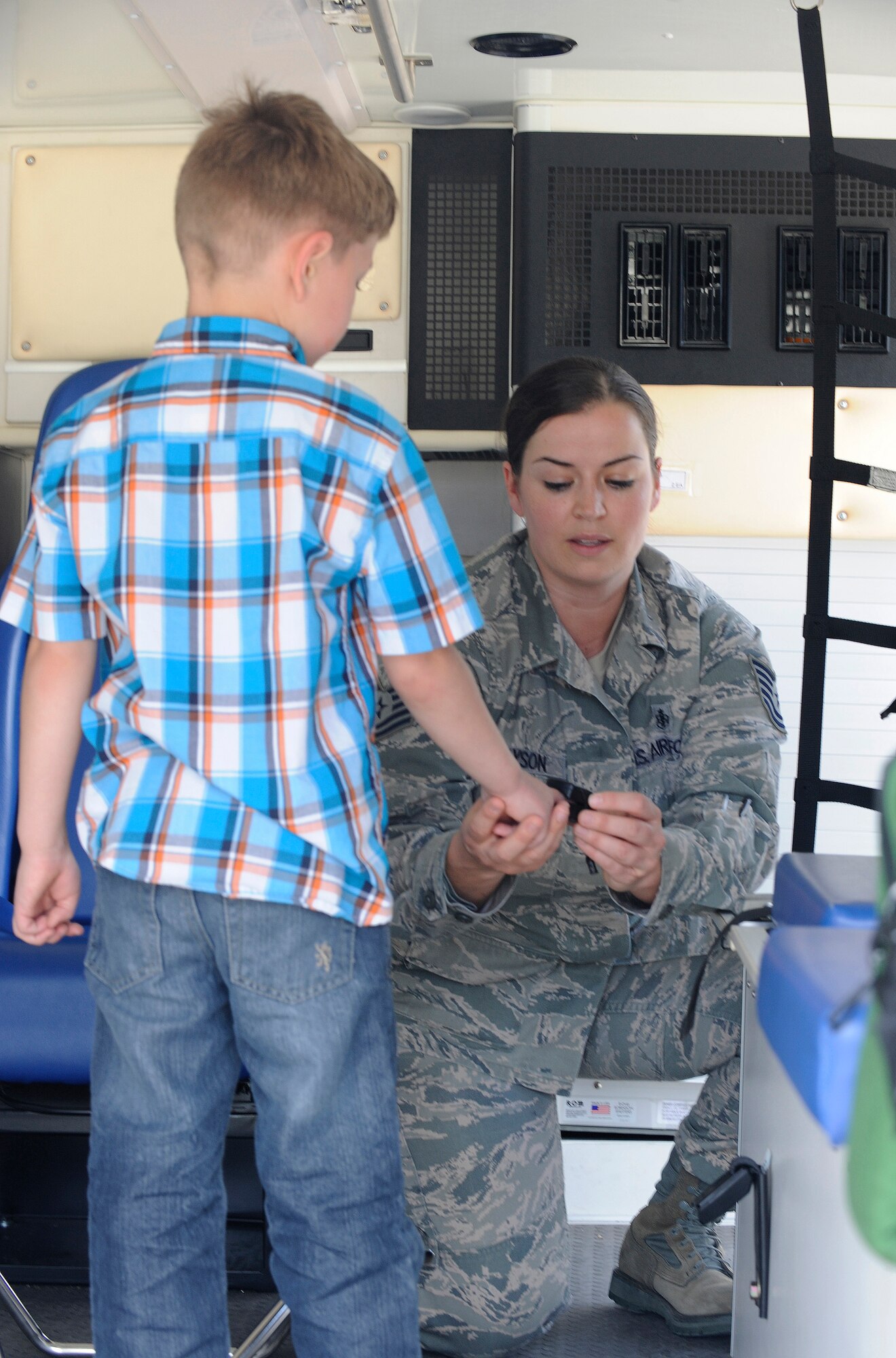 U.S. Air Force Tech. Sgt. Annie Grayson, 366th Medical Group emergency medical technician, gives Jaden Jenkins a tour of an ambulance, May 9, 2013, at Mountain Home Air Force Base, Idaho. As part of the base primary school’s second annual science fair, the 366th MDG made its presence known to local youth by holding an interactive ambulance and medical simulator demonstration. (U.S. Air Force photo by Airman 1st Class Shane M. Phipps/Released)

