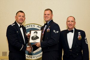 Col. Richard McComb, Joint Base Charleston commander, and Chief Master Sgt. Al Hannon, 628th Air Base Wing command chief, present Senior Airman Drew Cody , 437th Operations Support Squadron intelligence analyst, the Levitow Award during the Airman Leadership School Class 13-D graduation ceremony May 9, 2013, at Joint Base Charleston – Air Base, S.C. The Levitow Award is awarded for a student's exemplary demonstration of excellence, both as a leader and scholar. (U.S. Air Force photo/ Senior Airman George Goslin)