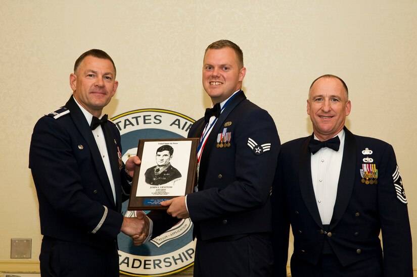 Col. Richard McComb, Joint Base Charleston commander, and Chief Master Sgt. Al Hannon, 628th Air Base Wing command chief, present Senior Airman Drew Cody , 437th Operations Support Squadron intelligence analyst, the Levitow Award during the Airman Leadership School Class 13-D graduation ceremony May 9, 2013, at Joint Base Charleston – Air Base, S.C. The Levitow Award is awarded for a student's exemplary demonstration of excellence, both as a leader and scholar. (U.S. Air Force photo/ Senior Airman George Goslin)