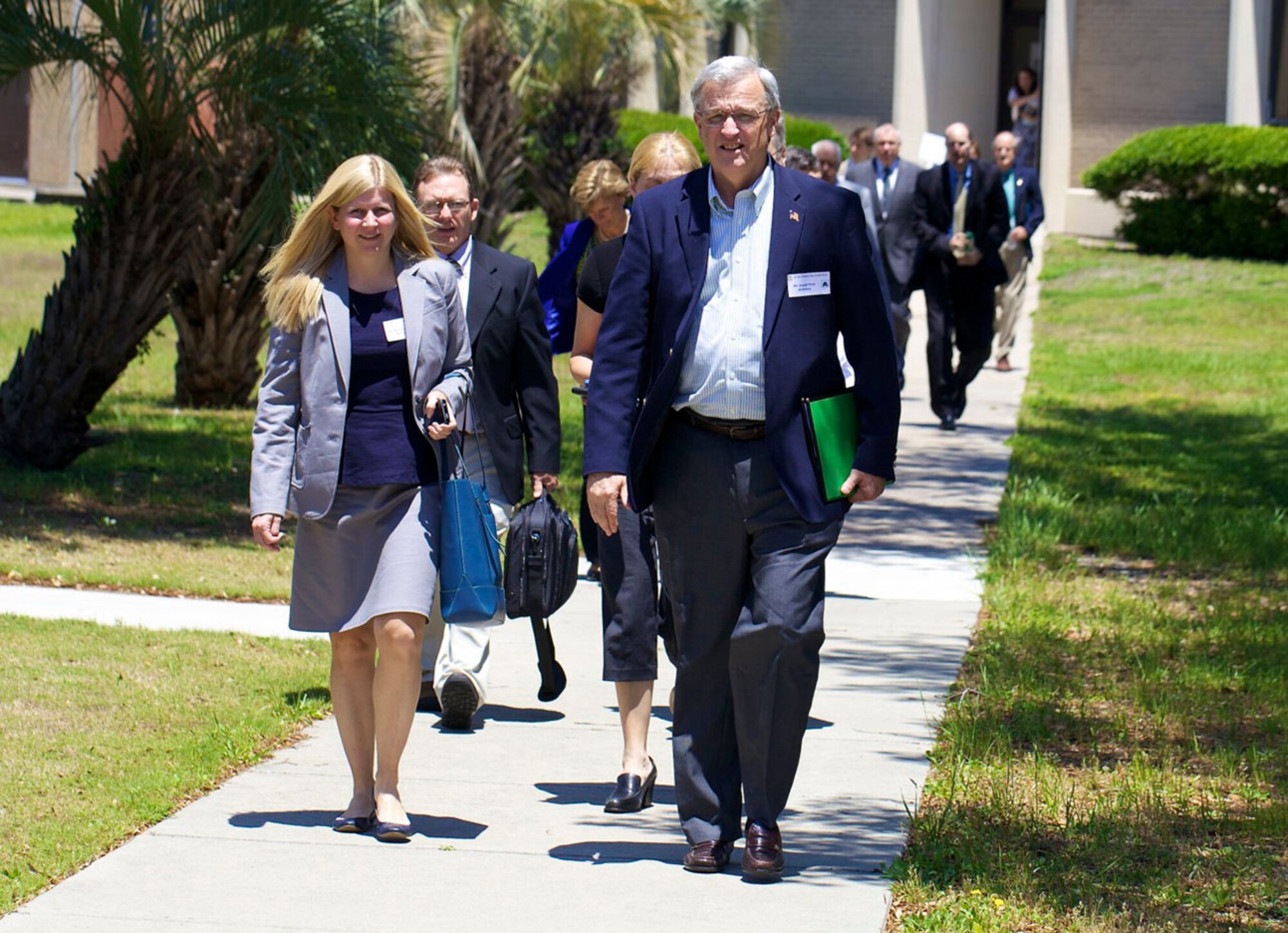 A group of business leaders travel between presentations at the 2013 Industry Day Forum held by the Air Force Civil Engineer Center at Tyndall Air Force Base, Fla., on May 7. Representatives from 75 companies attended the event, held to give military and industry leaders a chance to discuss public-private collaboration opportunities to help meet the Air Force’s civil engineering needs. (U.S. Air Force photo/Eddie Green)