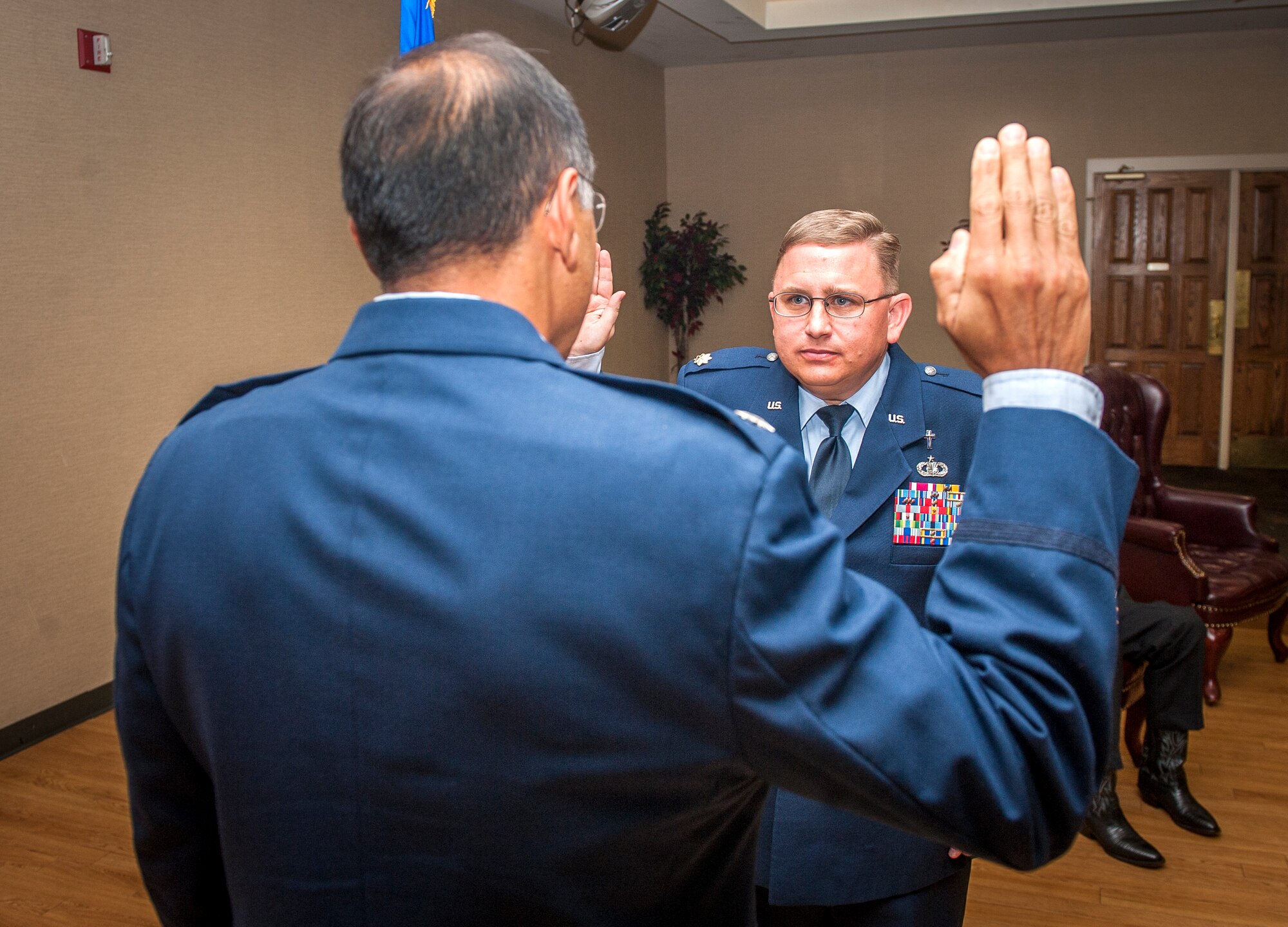 U.S. Air Force Chaplain (Maj.) Erik Harp, 93d Air Ground Operations Wing chaplain, recites the Oath of Enlistment during a promotion ceremony at Moody Air Force Base, Ga., April 30, 2013. O’Sullivan also administered the Oath of Enlistment to Harp when he re-enlisted at Price Sultan Air Base, Saudi Arabia, in July 1997. (U.S. Air Force photo by Senior Airman Jarrod Grammel/Released)
