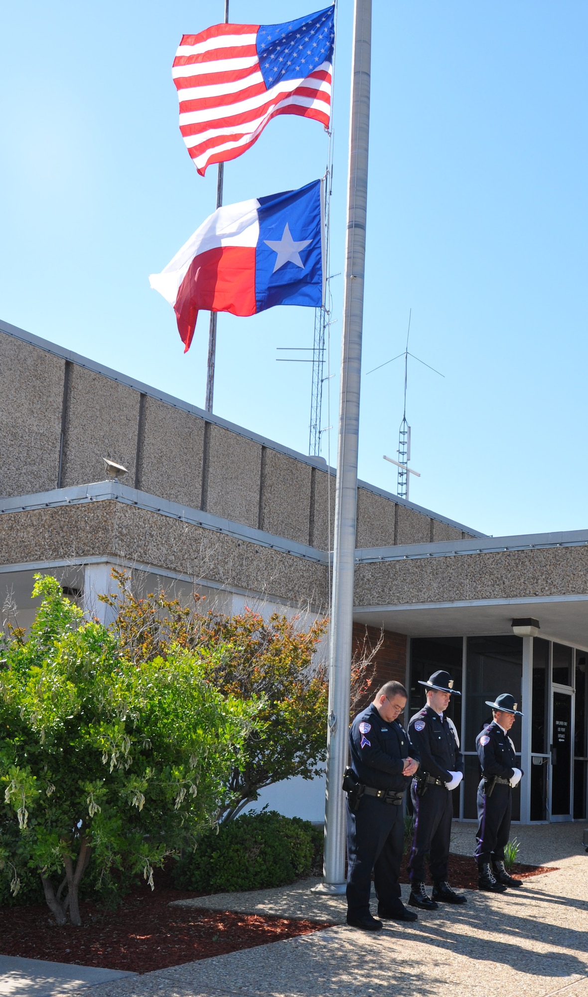 SAN ANGELO, Texas- The flags stand at half-staff to honor fallen law enforcement officers for National Police Week at the San Angelo Police Department, May 3.  Members from the 17th Security Forces Squadron, local elementary school students, SAPD police officers and San Angelo community members attended the event to honor those lost in the line of duty and law enforcement officers everywhere.  (U.S. Air Force photo/ Airman 1st Class Erica Rodriguez)