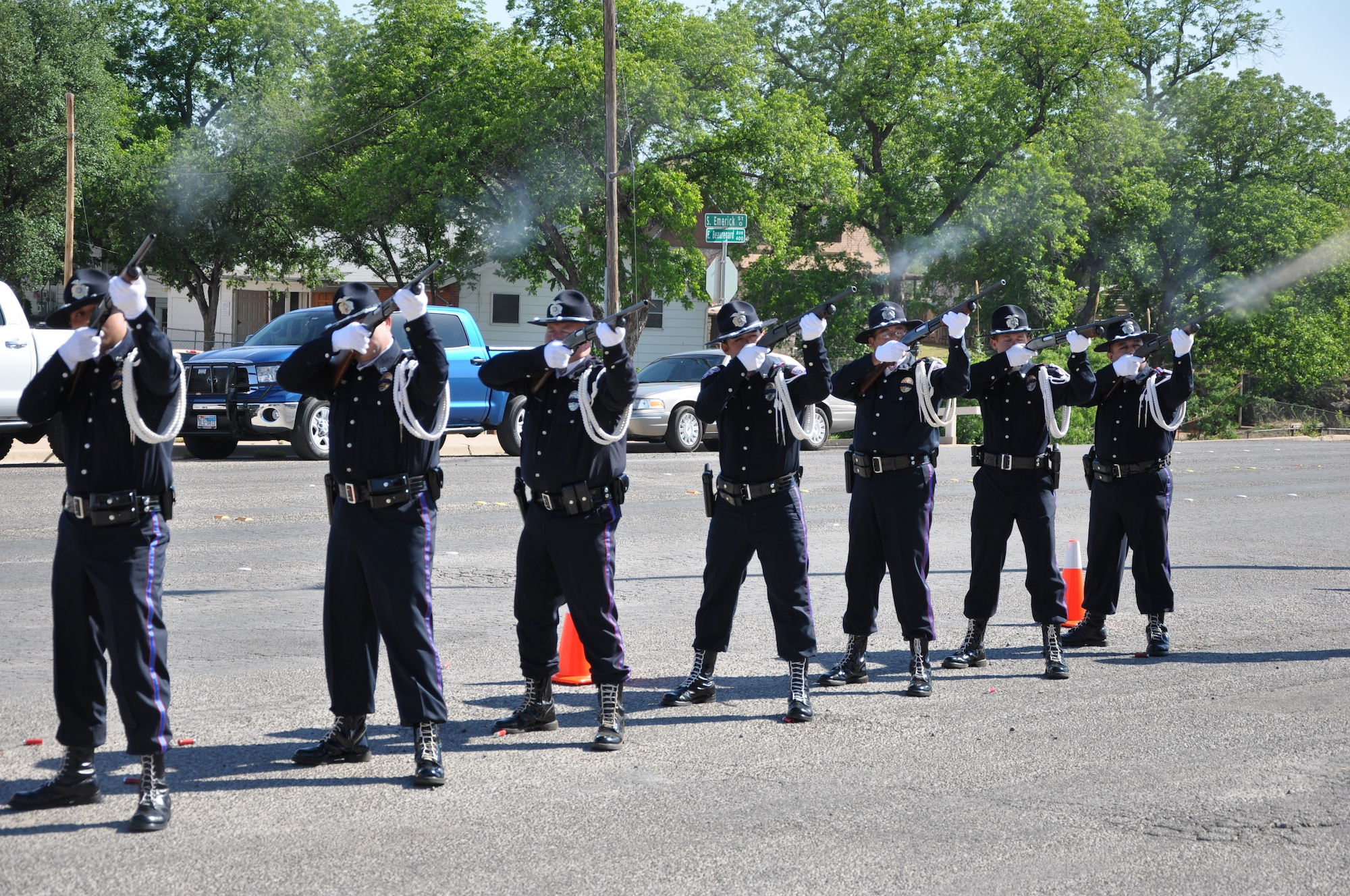 SAN ANGELO, Texas- Members from the San Angelo Police Department Honor Guard perform the 3-volley salute to honor fallen law enforcement officers during the flag raising ceremony at the SAPD, May 13. The flag raising ceremony was held to honor those lost in the line of duty and law enforcement officers everywhere for National Police Week. (U.S. Air Force photo/ Airman 1st Class Erica Rodriguez)