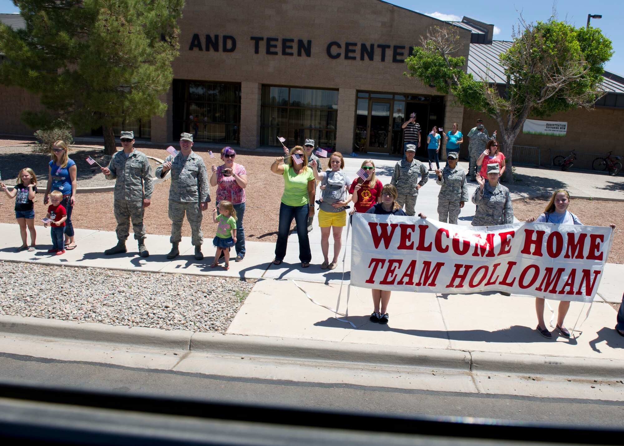 Family members and volunteers welcome home the “deployers” at the Youth and Teen Center during Operation Kids Investigating Deployment at Holloman Air Force Base, N.M., May 13. Operation K.I.D. gave the “deployers” an inside look at what their parents go through when called to deploy. (U.S. Air Force photo by Senior Airman Kasey Close/Released)