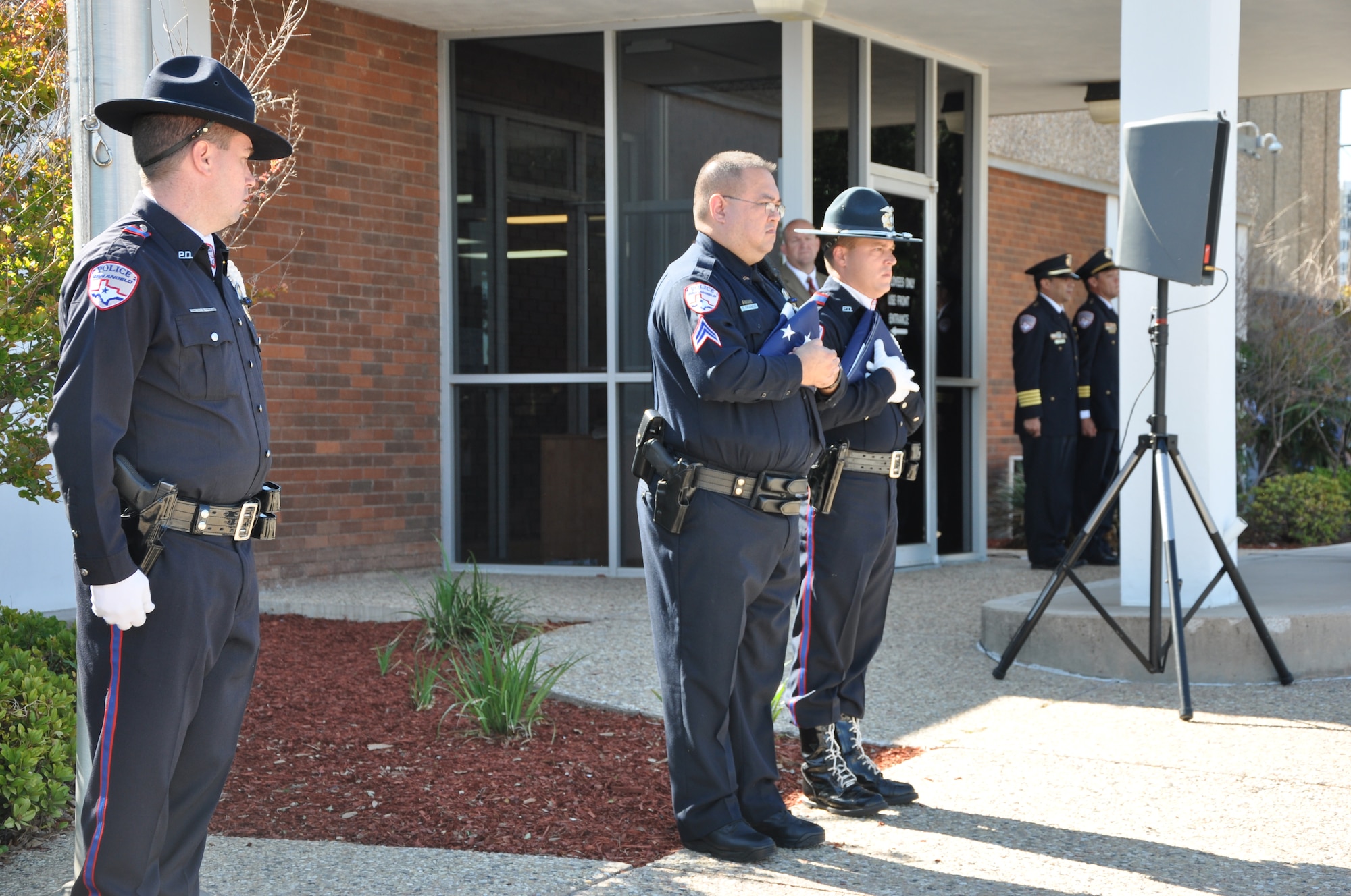 SAN ANGELO, Texas- Members from the San Angelo Police Department Honor Guard prepare to raise the flags at the SAPD, May 13. Members from the 17th Security Forces Squadron, local elementary school students, SAPD police officers and San Angelo community members attended the event to honor those lost in the line of duty and law enforcement officers everywhere. (U.S. Air Force photo/ Airman 1st Class Erica Rodriguez)