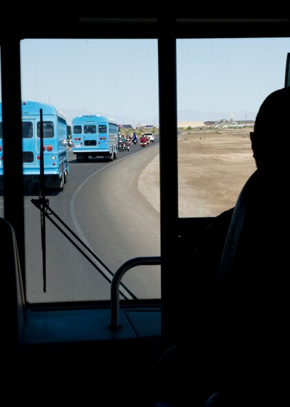 Buses packed with the “deployers” travel to the deployment processing line during Operation Kids Investigating Deployment at Holloman Air Force Base, N.M., May 13. The “deployers” experienced a recall, deployment line, deployment to “Bearghanistan,” and welcome home. (U.S. Air Force photo by Senior Airman Kasey Close/Released)