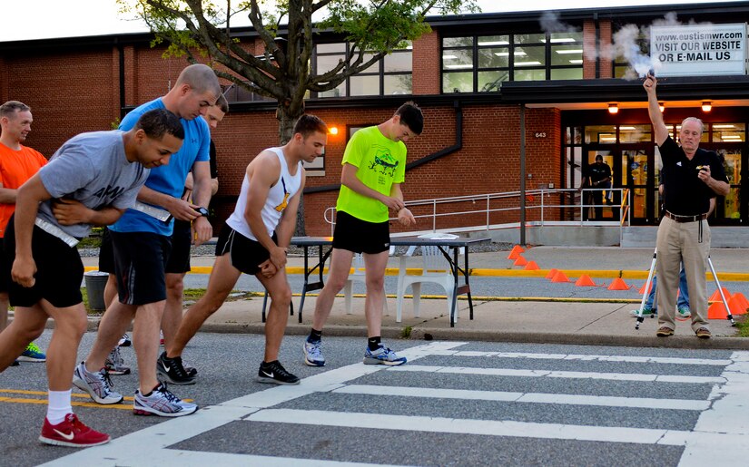 Bill Von Ohlen, Anderson Field House sports and fitness branch director (right), fires a pistol to signal the start of the Fort Eustis Running Club’s Army Ten-Miler team tryouts at Fort Eustis, Va., May 15, 2013. The running club meet on post and in the surrounding area to offer an easily accessible, comprehensive experience for all interested runners. (U.S. Air Force photo by Airman 1st Class R. Alex Durbin/Released)