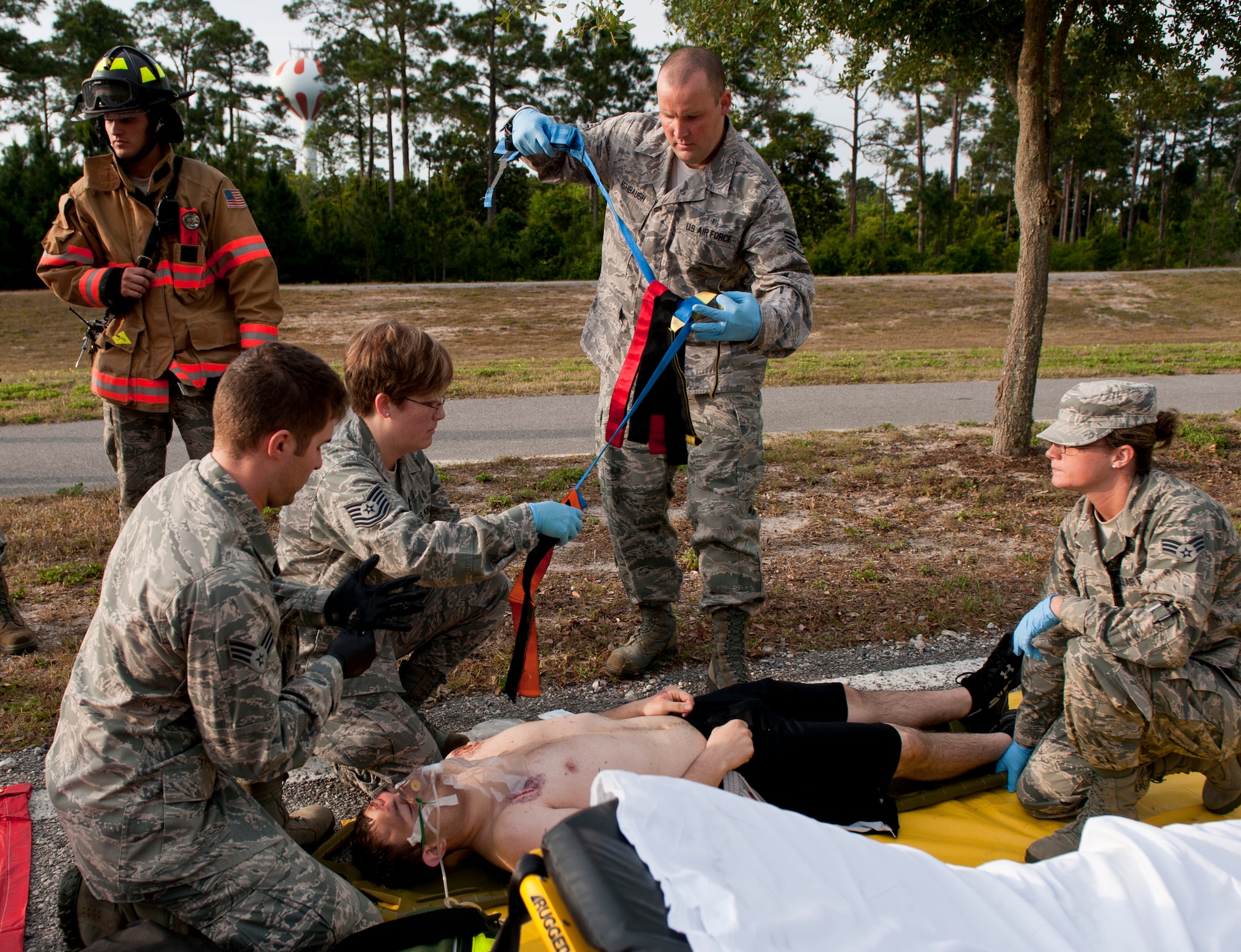 Medical personnel from 1st Special Operations Medical Group provide treatment for mock victims during a Chemical, Biological, Radiological, Nuclear and Explosive response training on Hurlburt Field, Fla., May 10, 2013. The training tested Hurlburt Field’s first responder’s ability to react to CBRNE-simulated scenarios and provide treatment to possible victims appropriate to each scenario. (U.S. Air Force photo by Senior Airman Krystal M. Garrett)