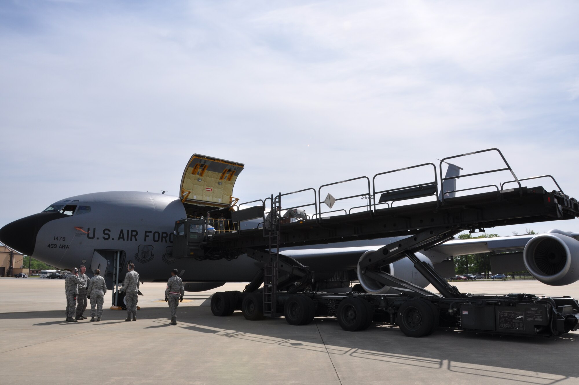 A K-Loader carrying two wing flaps from a B-17 Flying Fortress pulls up to a KC-135 Stratotanker from the 459th Air Refueling Wing, Joint Base Andrews, Md., while troops wait to unload the flaps onto the aircraft, May 14, 2013. The wing flaps, along with a “cherry blossom” rocket built in 1945 came from the Air and Space Museum of the Smithsonian Institution and the 459th ARW crew will transport both pieces of history to the National Museum of the United States of Air Force, Wright-Patterson Air Force Base, Ohio. (U.S. Air Force photo/Staff Sgt. Katie Spencer)