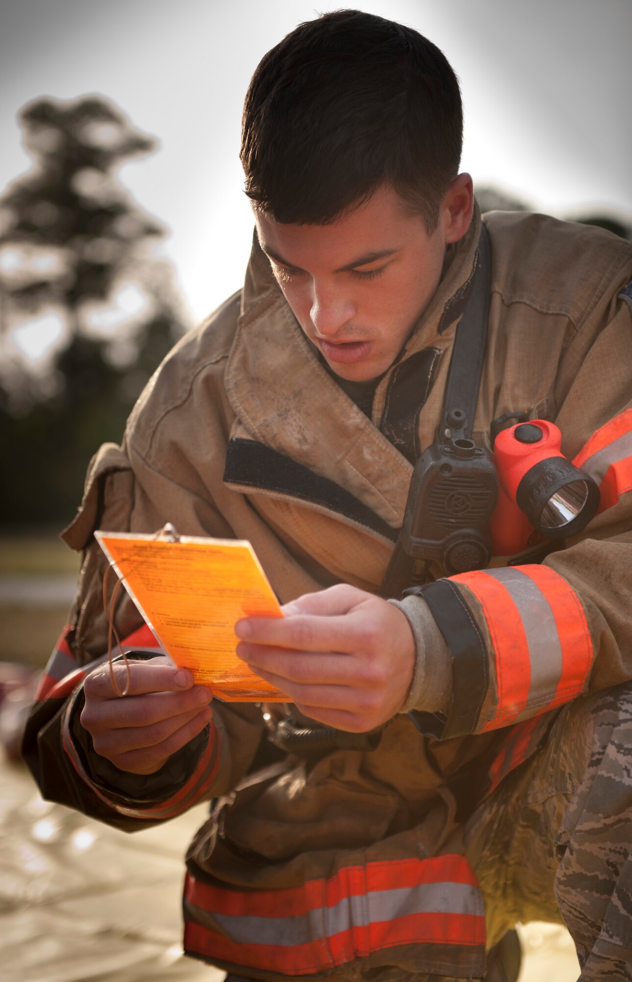 A 1st Special Operations Civil Engineer Squadron firefighter reads a card that describes the condition of mock victims during a Chemical, Biological, Radiological, Nuclear and Explosive response training on Hurlburt Field, Fla., May 10, 2013. The training tested Hurlburt Field’s first responder’s ability to react to CBRNE-simulated scenarios and provide treatment to possible victims appropriate to each scenario. (U.S. Air Force photo by Senior Airman Krystal M. Garrett)