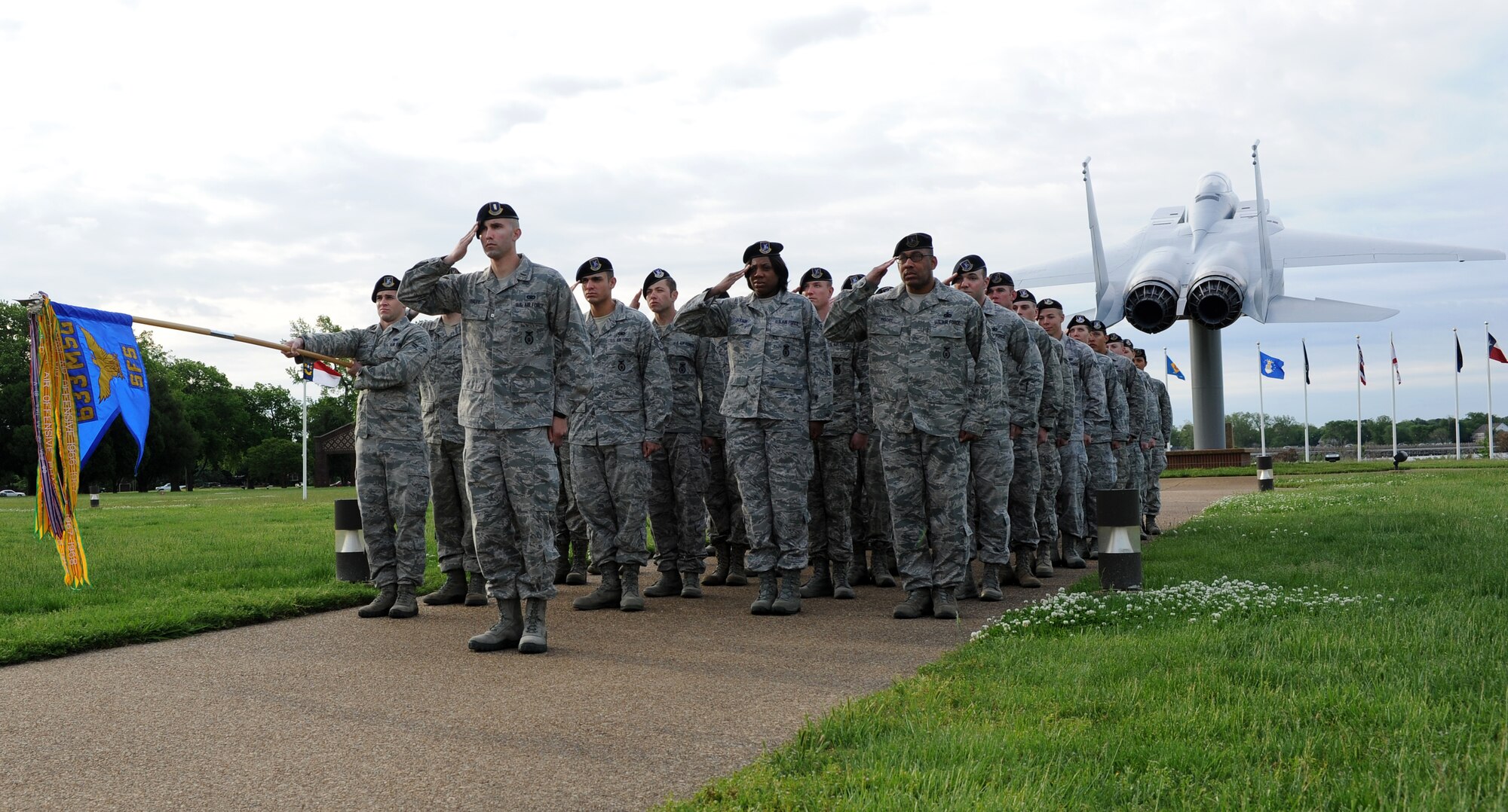 Airmen of the 633rd Security Forces Squadron salute during the raising of the American flag during the Peace Officers’ Memorial Ceremony held at Langley Air Force Base Va., May 13, 2013. The ceremony honored law enforcement officers who lost their lives in the line of duty. (Photo by U.S. Air Force Airman Areca T. Wilson/Released)