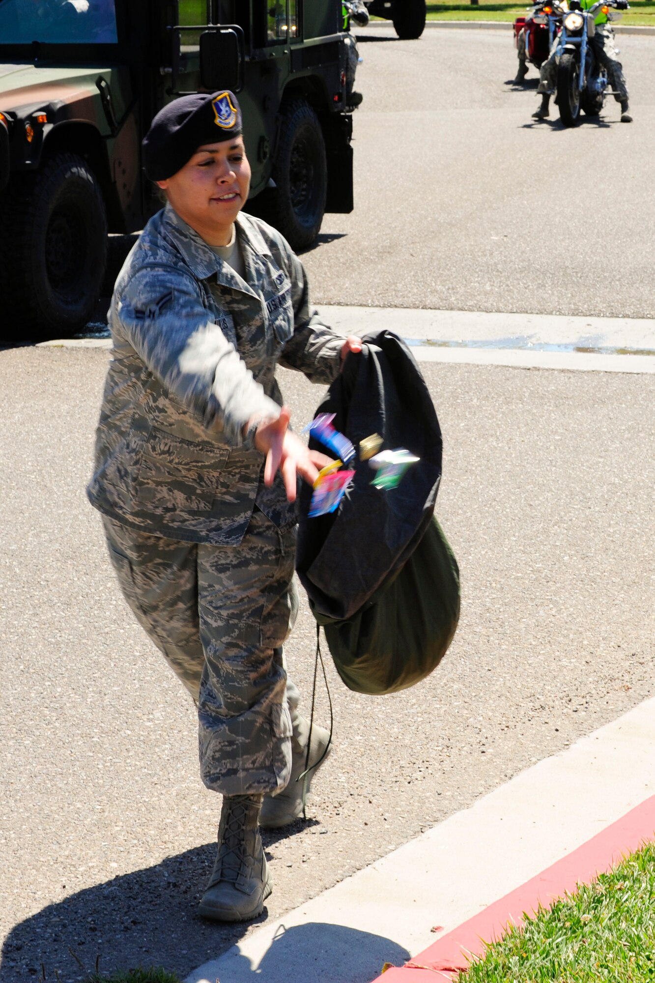 VANDENBERG AIR FORCE BASE, Calif. – A 30th Security Forces Squadron patrolman hands candy during Team V’s National Police Week parade here Monday, May 13, 2013. The 30th Security Forces Squadron hosted a parade on base for all military, civilians and their families as part of their National Police Week celebration. The event, which included Team V defenders and local law enforcement agencies, showcased many different types of vehicles and animals law enforcement agencies use. (U.S. Air Force photo/Airman Yvonne Morales)
