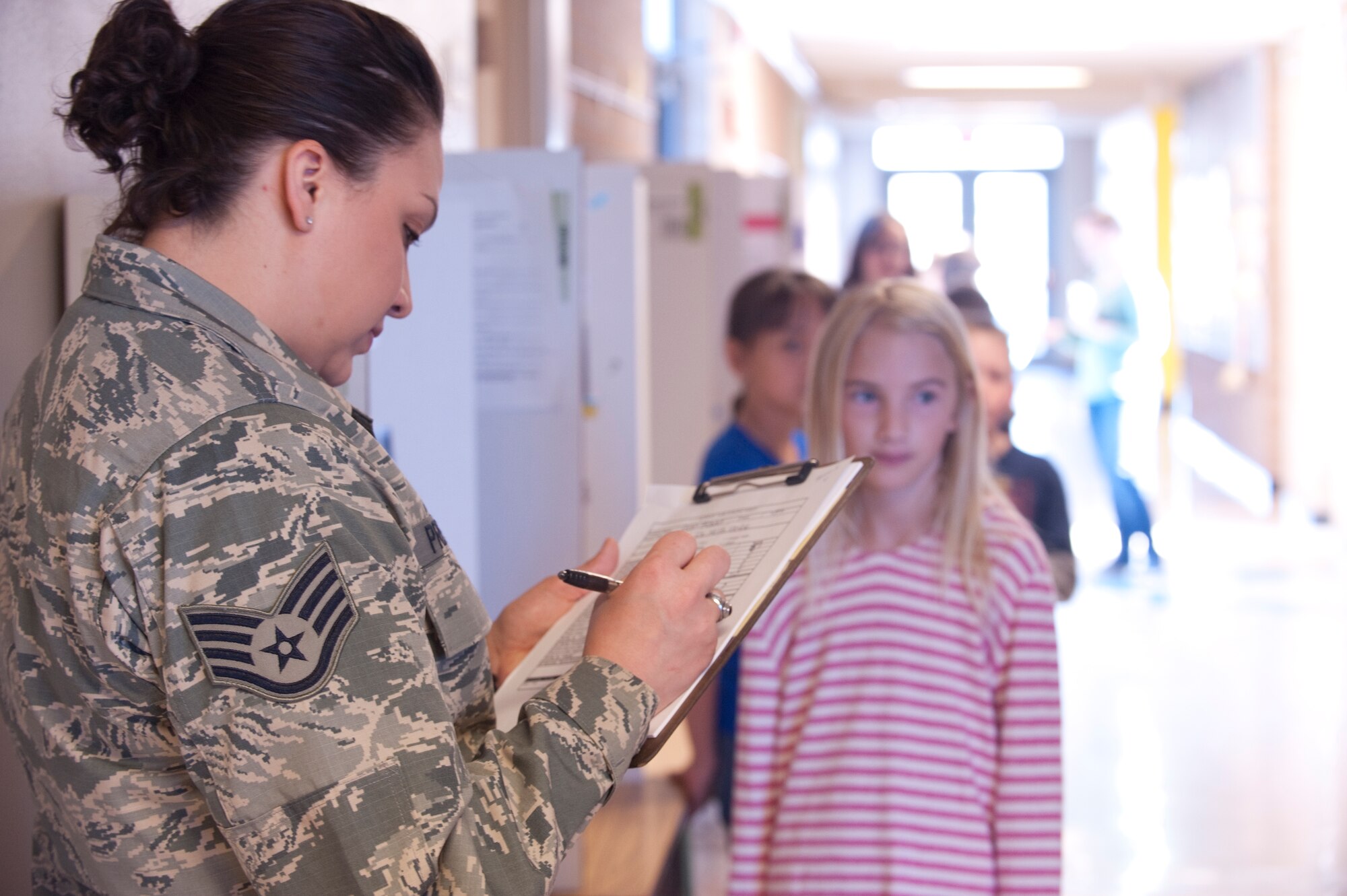 Staff Sgt Evon Pretulak, Equal Opportunity Director, grades a science project at the Base Primary School at Mountain Home Air Force Base, Idaho, May 9, 2013. Pretulak enjoyed being a science fair judge and the opportunity to work with many of the students. (U.S. Air Force Photo by Airman 1st Class Malissa Lott)(Released)