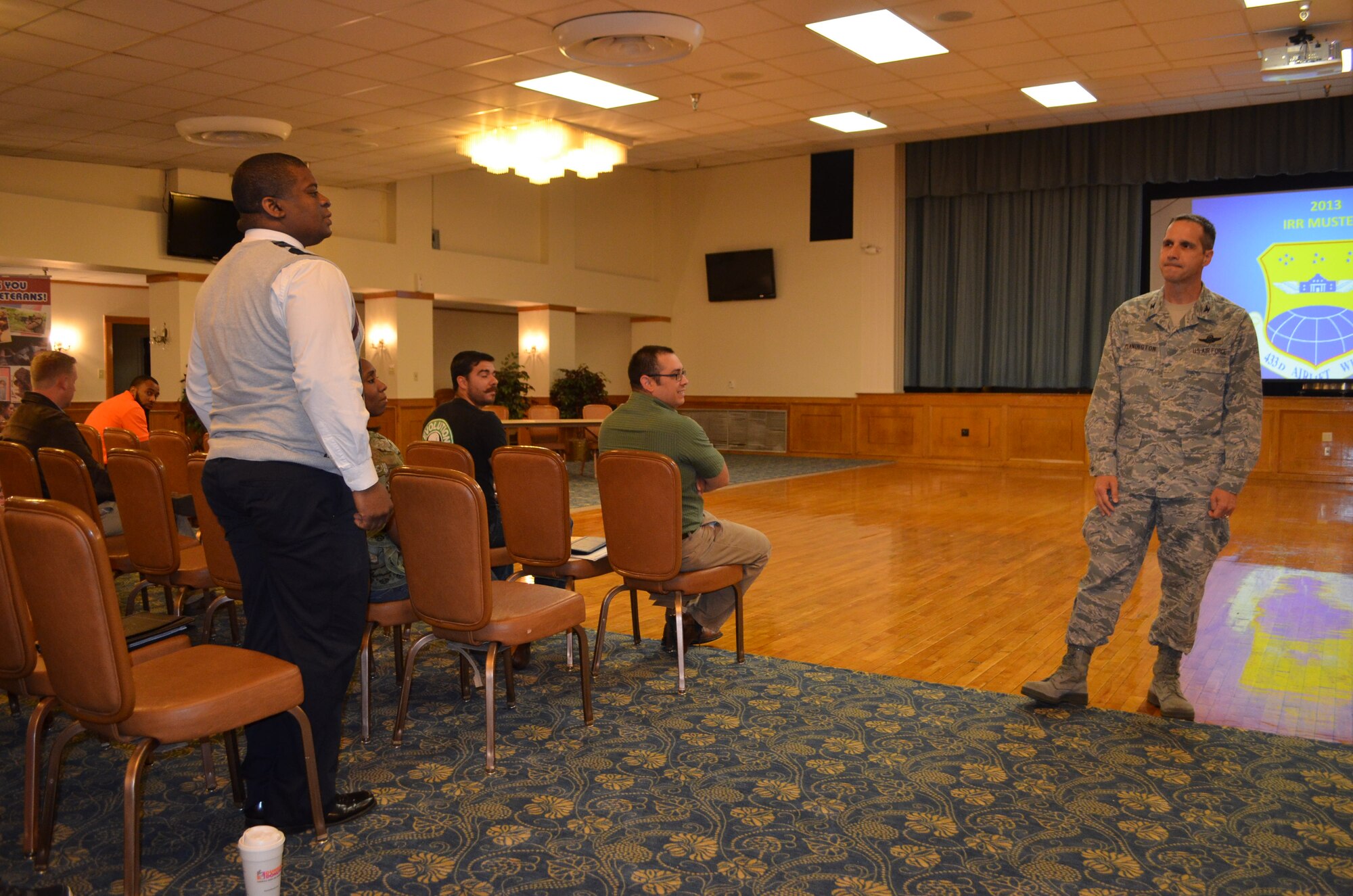 Cecilio Rosales, a former U.S. Army Reservist, asks Col. Jeffrey T. Pennington, 433rd Airlift Wing commander, about commissioning opportunities in the wing.Rosales was one of 162 prior-service military members who attended the 433rd AW's Individual Ready Reserve muster, held May 15 at Joint Base San Antonio-Lackland's Mitchell Hall May 15, 2013. (U.S. Air Force Photo/ Maj. Tim Wade) 