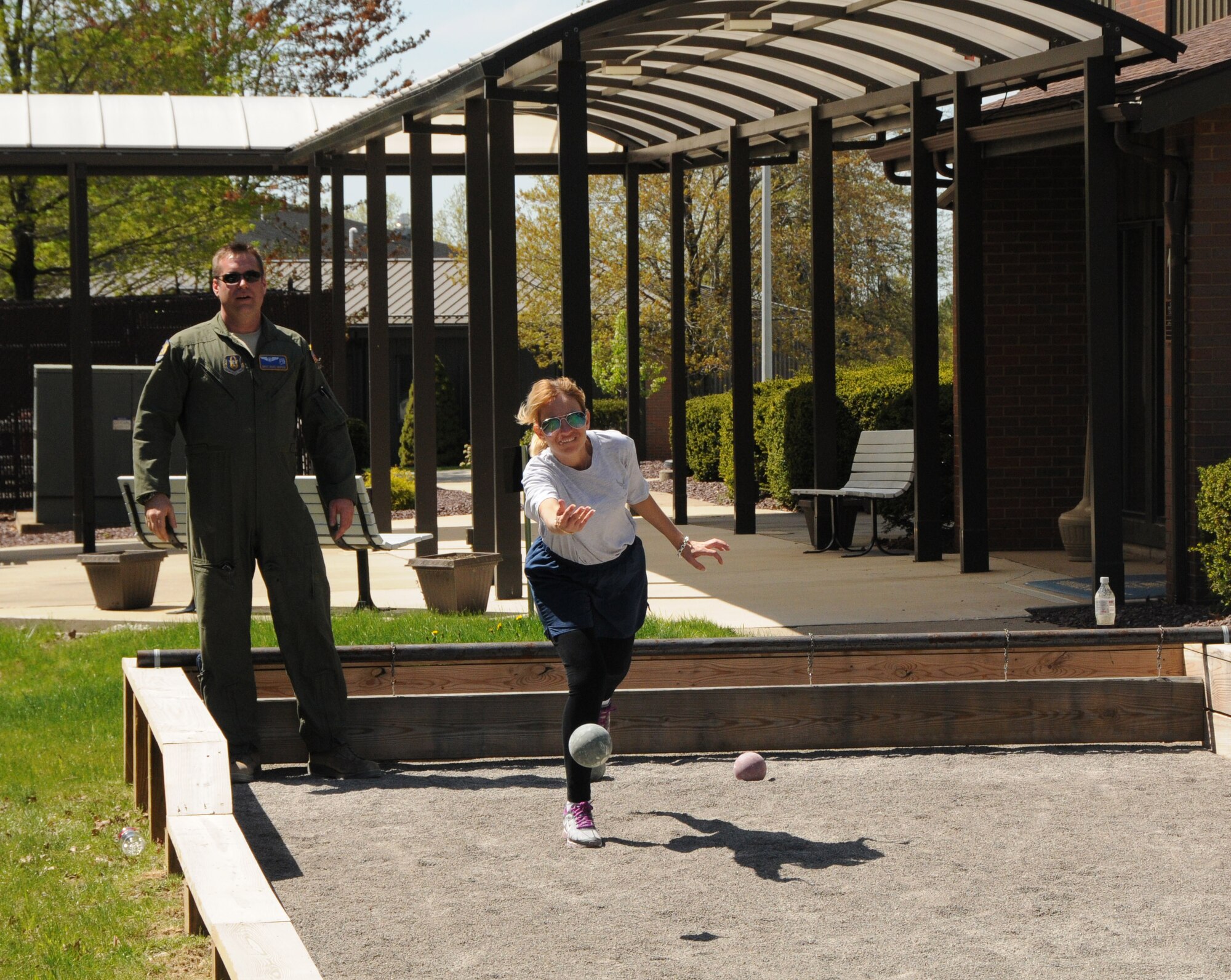 Master Sgt. Michelle Kaszowski, and Airman with the 910th Medical Squadron, tosses a ball during a game bocce with Master Sgt. Mark Marino observing. Bocce was of the many activities the 910 offered as part of their annual Wingman Day.