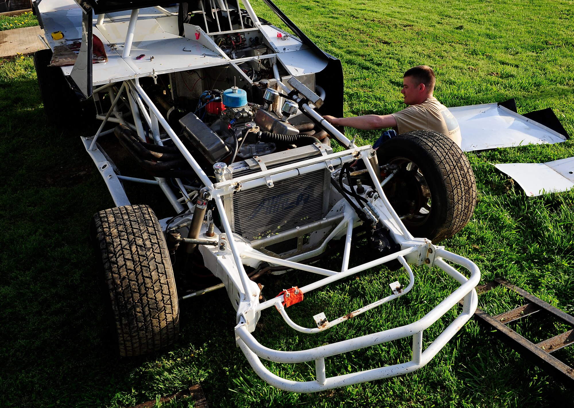 Staff Sgt. Chris Brockway, 442nd Logistics Readiness Squadron traffic management office apprentice, repairs a muffler on his B-Modified racecar in Warrensburg, Mo., April 29, 2013. Brockway must keep all pieces of his car in strict adherence with racetrack rules or risk disqualification. (U.S. Air Force photo by Airman 1st Class Shelby R. Orozco/Released)