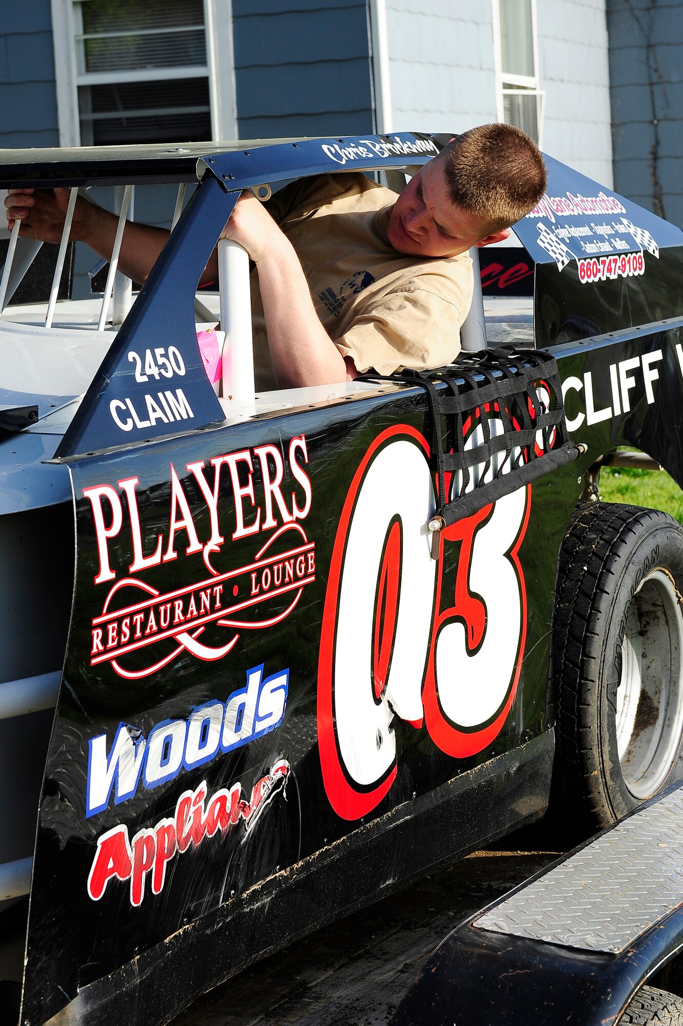 Staff Sgt. Chris Brockway, 442nd Logistics Readiness Squadron traffic management office apprentice, climbs into his B-Modified racecar to unload it from its trailer in Warrensburg, Mo., April 29, 2013. Brockway is racing for national points this year. (U.S. Air Force photo by Airman 1st Class Shelby R. Orozco/Released)