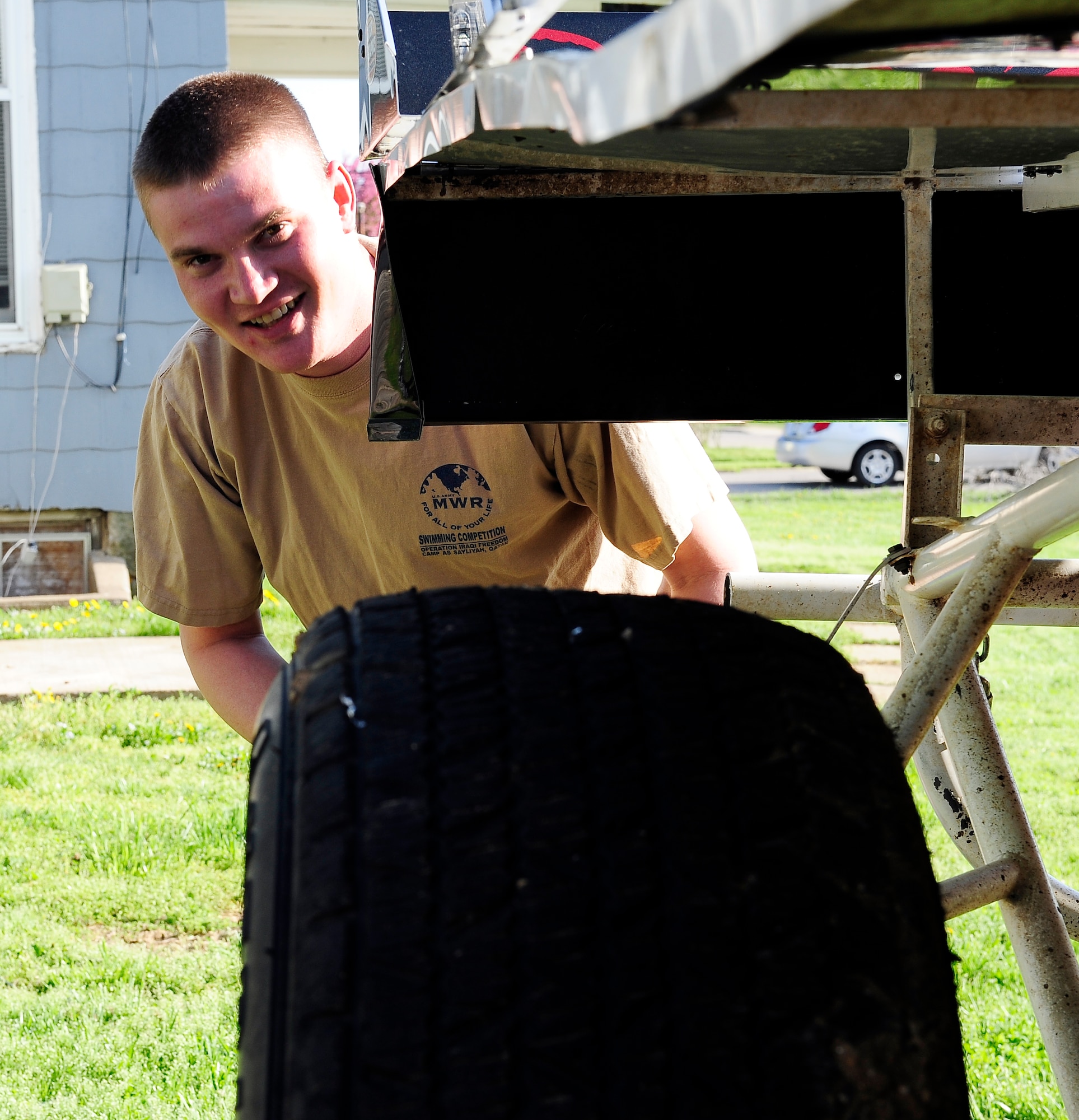 Staff Sgt. Chris Brockway, 442nd Logistics Readiness Squadron traffic management office apprentice, smiles from behind his B-Modified racecar in Warrensburg, Mo., April 29, 2013. Brockway has been racing for almost eight years. (U.S. Air Force photo by Airman 1st Class Shelby R. Orozco/Released)