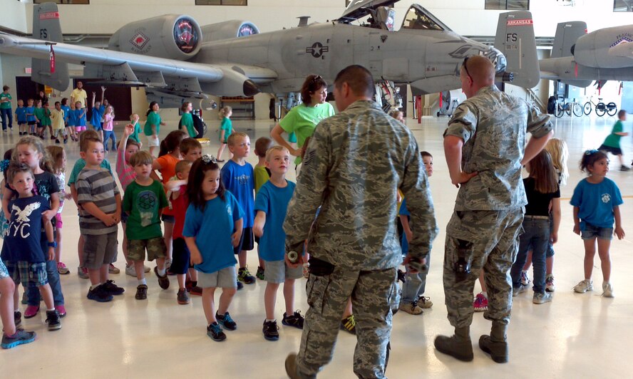 Tech Sgt. Roderic Ventresca, left, and Master Sgt. Paul Denton speak with a group of kindergarteners from Alma Primary School during a tour of the 188th Fighter Wing May 14, 2013.. (U.S. Air National Guard photo by Maj. Heath Allen/188th Fighter Wing)
