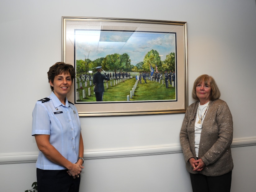 Col. Gina Humble, 11th Operations Group commander, left, and Lyn Gosman, Humble's hairdresser and professional painter, reveal "A Nation's Tribute" during a small ceremony at Joint Base Anacostia-Bolling Jan. 2013. (U.S. Air Force photo/Staff Sgt. Torey Griffith)