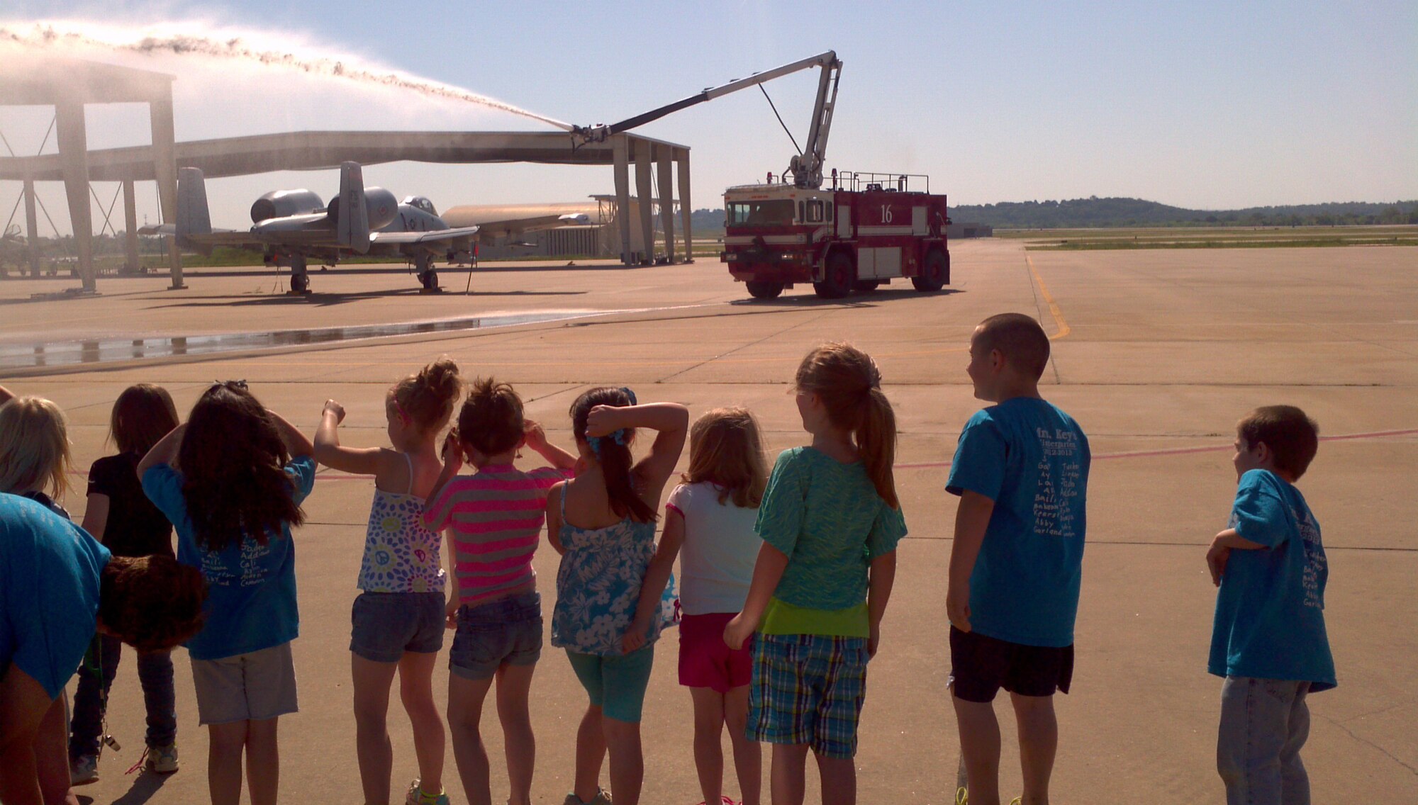 Firefighters with the 188th Fire Emergency Services Flight provide a fire truck exhibition for a group of kindergarteners from Alma Primary School during a tour of the 188th Fighter Wing May 14, 2013. (U.S. Air National Guard photo by Maj. Heath Allen/188th Fighter Wing)