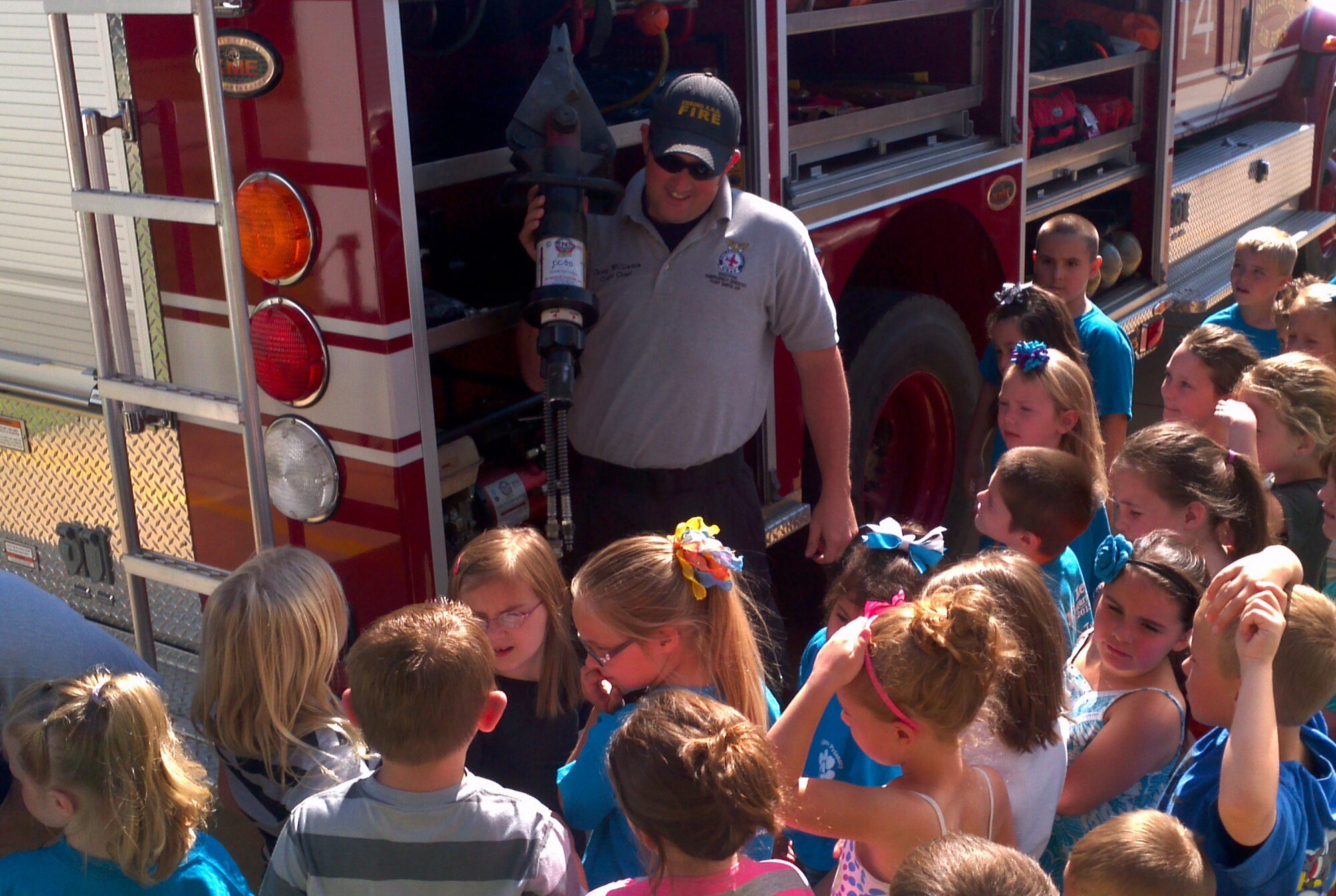 Staff Sgt. Greg Williams, a firefighter with the 188th Fire Emergency Services Flight, speaks with a group of kindergarteners from Alma Primary School during a tour of the 188th Fighter Wing May 14, 2013. (U.S. Air National Guard photo by Maj. Heath Allen/188th Fighter Wing)