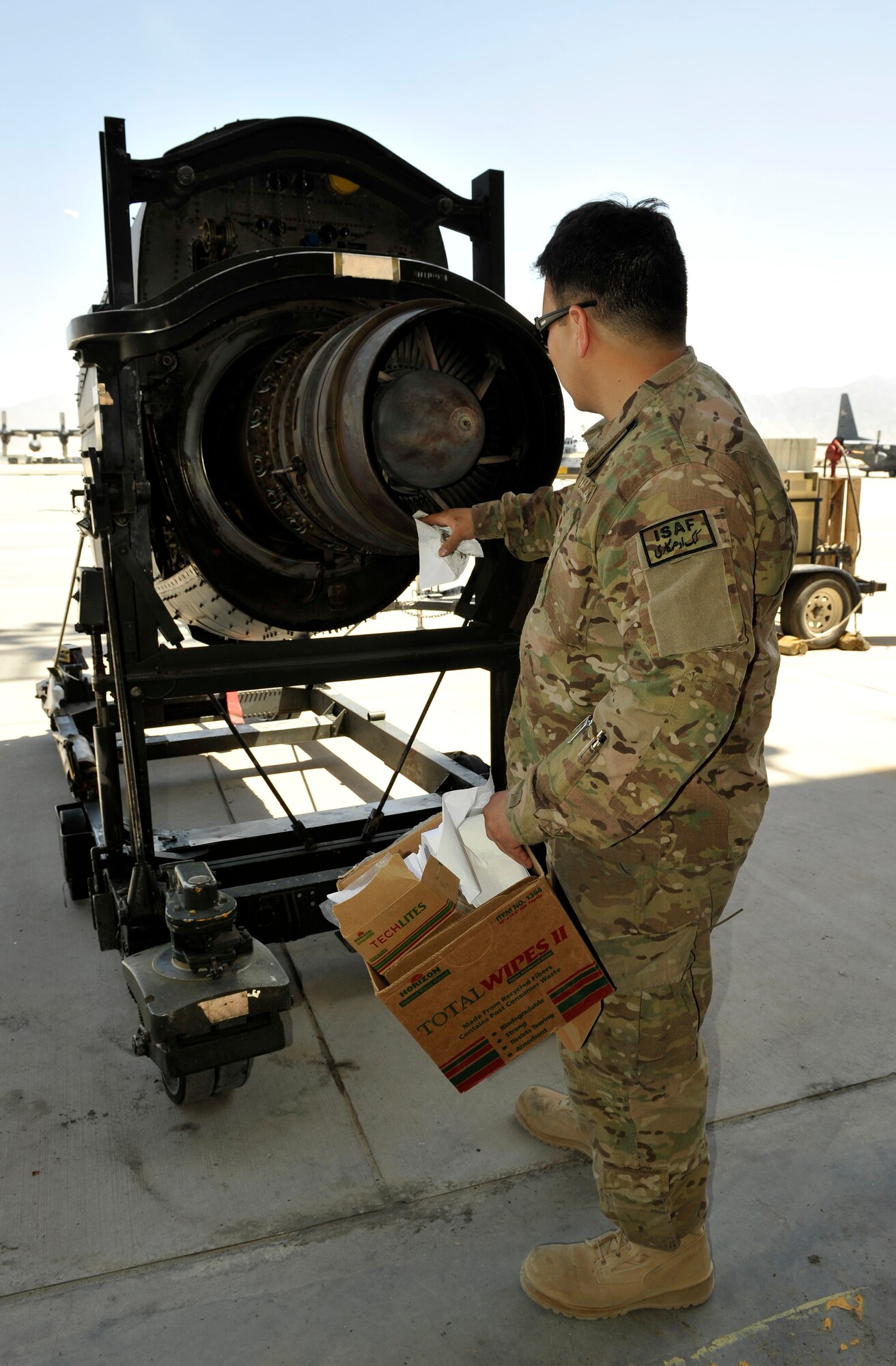 Staff Sgt. Christopher Contreras, 455th Aircraft Maintenance Squadron C-130 maintainer, cleans dirt and water out of an engine prior to a customs inspection on Bagram Airfield, Afghanistan, May 13, 2013. The engine must be clean of dirt, water, insects and vegetation prior to customs approving it for shipment. Contreras is deployed from Little Rock Air Force Base, Ark. (U.S. Air Force photo/Staff Sgt. Stephenie Wade)