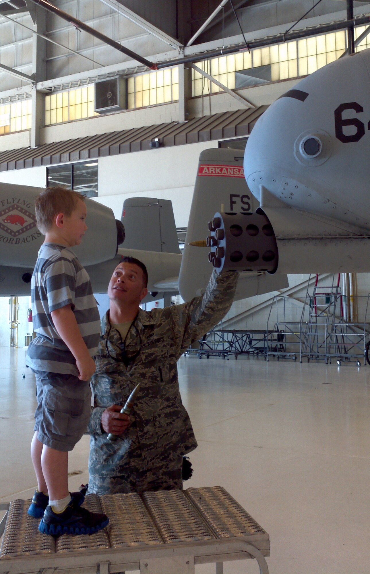 Tech Sgt. Roderic Ventresca speaks with a kindergartener from Alma Primary School during a tour of the 188th Fighter Wing May 14, 2013. (U.S. Air National Guard photo by Maj. Heath Allen/188th Fighter Wing)
