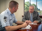 Retired Air Force Chief Master Sgt. BT Parcenue, Headquarters Air Education and Training Command chief of Airfield Operations, leads a daily meeting with Master Sgt. Wade Glegg, air traffic control training and operations manager, May 7 Joint Base San Antonio-Randolph. Parcenue is retiring June 28 after 51 years of combined federal service, including 30 years as an active-duty member, 20 years in airfield operations as a civil servant and one year as an Air Force contractor.  (U.S. Air Force photo by Joshua Rodriguez / Released