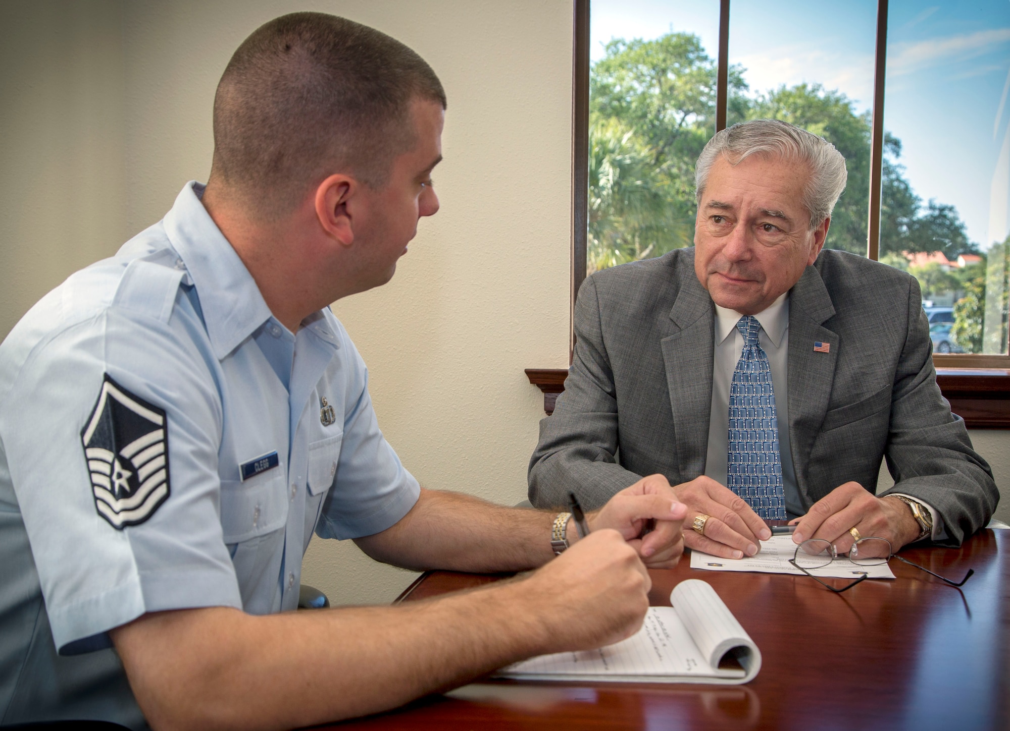 Retired Air Force Chief Master Sgt. BT Parcenue, Headquarters Air Education and Training Command chief of Airfield Operations, leads a daily meeting with Master Sgt. Wade Glegg, air traffic control training and operations manager, May 7 Joint Base San Antonio-Randolph. Parcenue is retiring June 28 after 51 years of combined federal service, including 30 years as an active-duty member, 20 years in airfield operations as a civil servant and one year as an Air Force contractor.  (U.S. Air Force photo by Joshua Rodriguez / Released