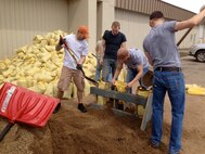 MINOT, N.D. -- Volunteers from Minot AFB and the surrounding community converted a few piles of sand and dirt into more than 1,000 sandbags as part of the recent flood preparations. The volunteers were also crucial in making approximately 3,000 sandbags in Burlington. (Courtesy photo)