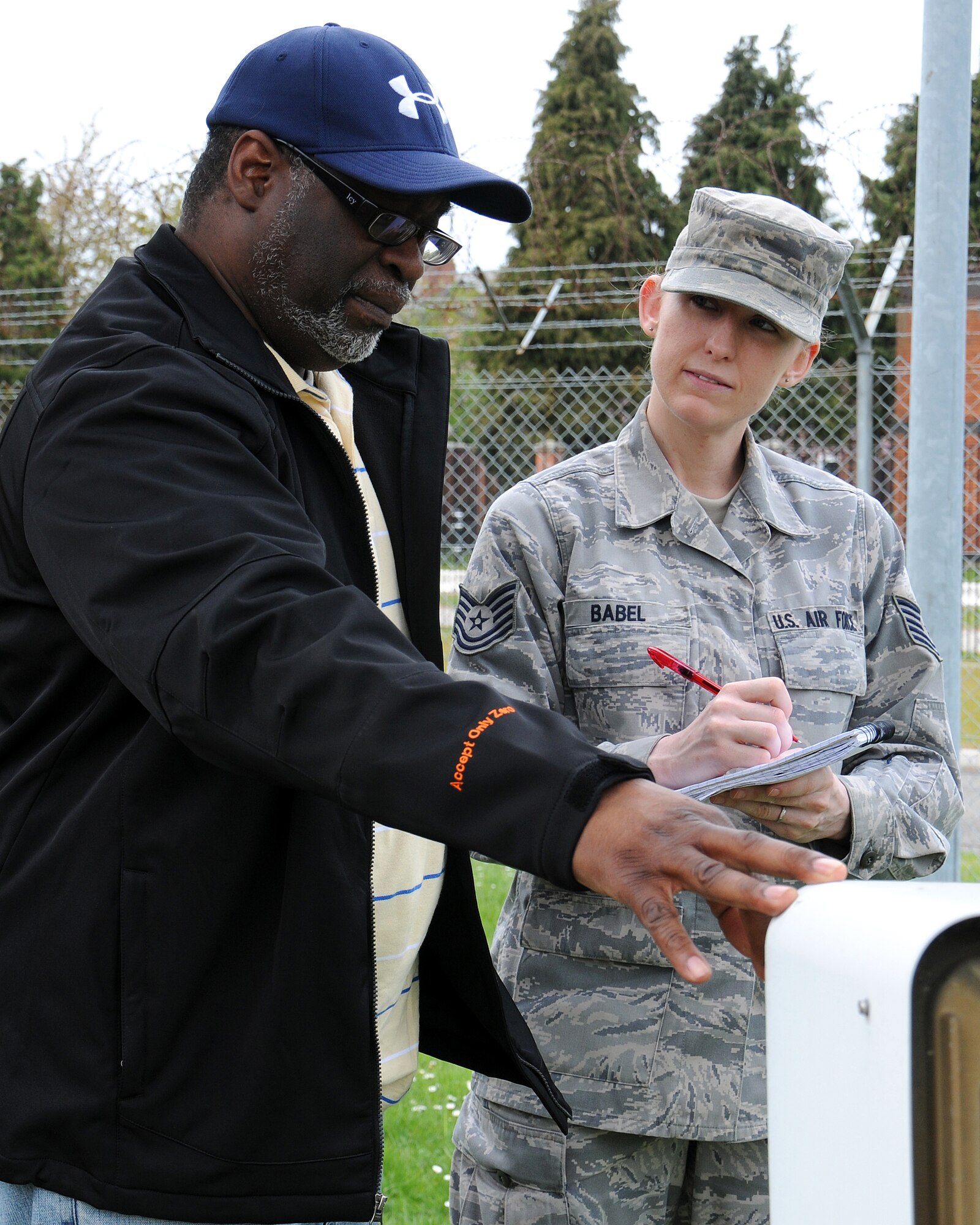 From left, Mark Stewart, 100th Communication Squadron contractor and contract manager from Charleston, S.C., informs Tech. Sgt. Marlane Babel, 100th CS NCO in charge of program management from El Paso, Texas, of plans for an ultra high frequency radio relocation project May 7, 2013, at RAF Mildenhall, England. The project management section of the shop manages all projects on the installation that have communication requirements as part of the project.   (U.S. Air Force photo by Gina Randall/Released)