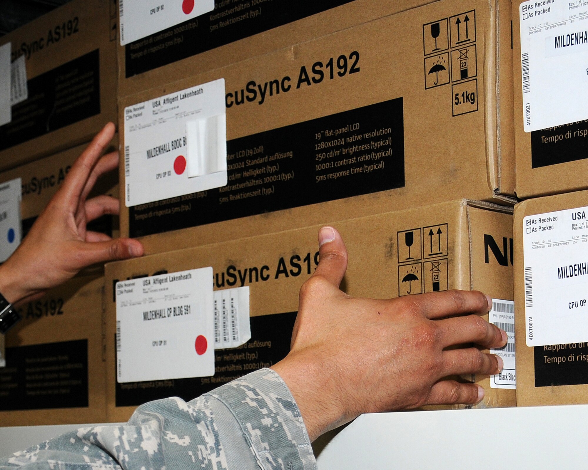 Staff Sgt. Juan Vasquez Perez, 100th Communication Squadron NCO in charge of requirements and architecture from Santo Domingo, Dominican Republic, inventories new servers May 7, 2013, at RAF Mildenhall, England. The requirements section of the 100th CS process more than 2,000 new base communications requirements every year. (U.S. Air Force photo by Gina Randall/Released)