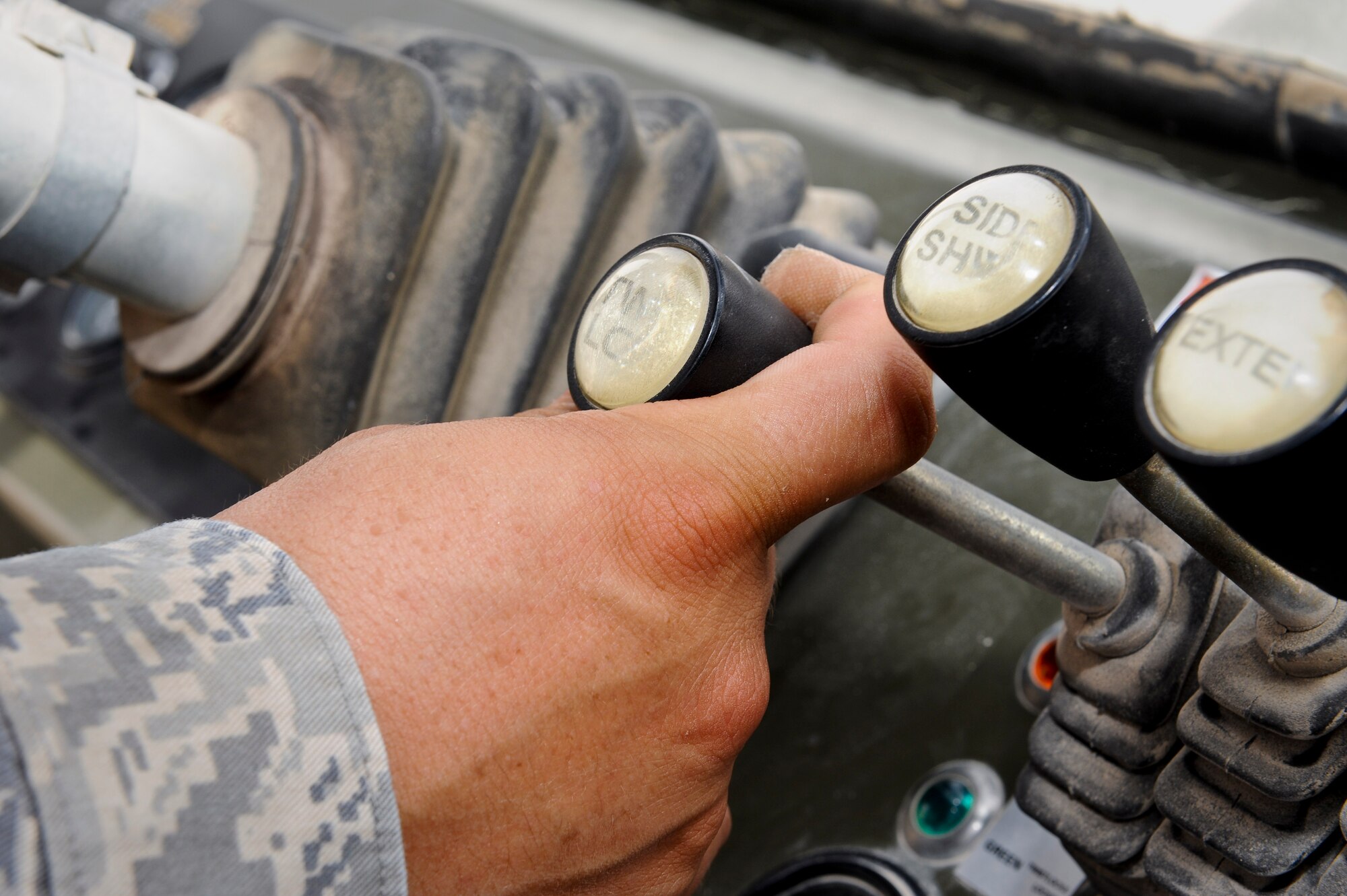 Staff Sgt. Roque Solis maneuvers a 50K Rough Terrain Container Handler during his duties at the 379th Air Expeditionary Wing in Southwest Asia, May 14, 2013. Solis is a 379th Expeditionary Logistics Readiness Squadron vehicle operator and deployed from Fairchild Air Force Base, Wash. (U.S. Air Force photo/Senior Airman Benjamin Stratton)