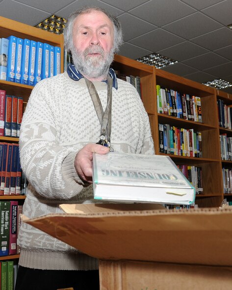 Peter Rouse, 100th Force Support Squadron Library technician from Mildenhall, Suffolk, boxes up books to transport to other libraries at U.S. Air Forces in Europe bases May 3, 2013, at the library on RAF Mildenhall, England. The base library is able to get materials from other USAFE libraries. (U.S. Air Force photo by Gina Randall/Released)