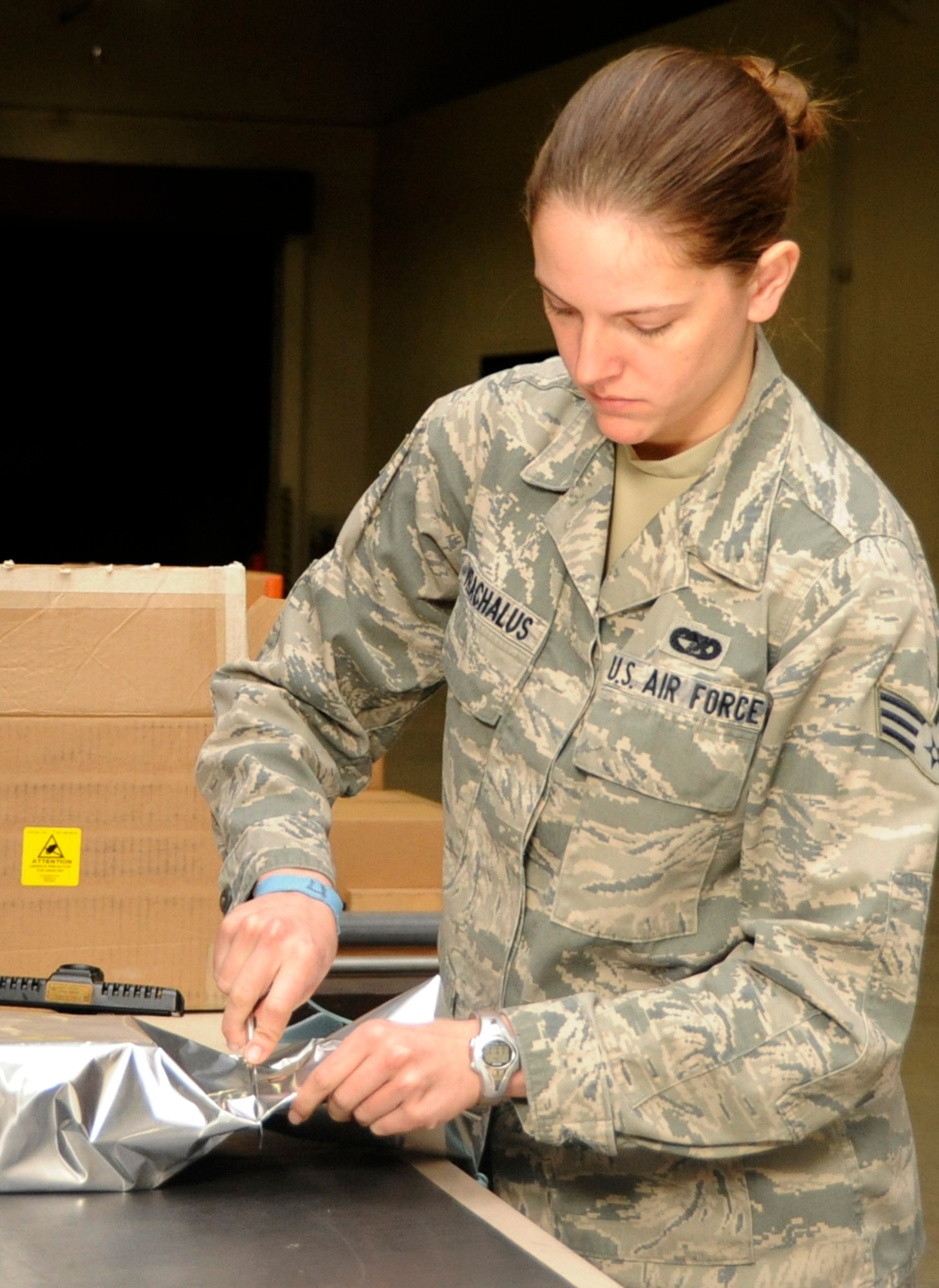 Senior Airman Sarah Varchalus, 35th Logistics Readiness Squadron outbound clerk, wraps an electro-static sensitive device in preparation for mailing at Misawa Air Base, Japan, April 30, 2013. The 35th Maintenance Group and 35th Logistics Readiness Squadron recently finished an evaluation from the Logistics Compliance Assessment Program. (U.S. Air Force photo by Airman 1st Class Kaleb Snay)
