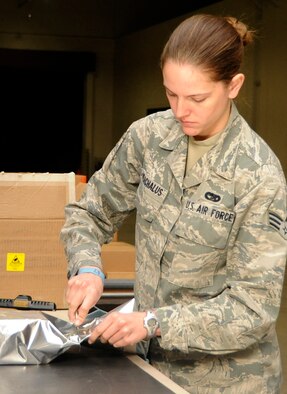 Senior Airman Sarah Varchalus, 35th Logistics Readiness Squadron outbound clerk, wraps an electro-static sensitive device in preparation for mailing at Misawa Air Base, Japan, April 30, 2013. The 35th Maintenance Group and 35th Logistics Readiness Squadron recently finished an evaluation from the Logistics Compliance Assessment Program. (U.S. Air Force photo by Airman 1st Class Kaleb Snay)