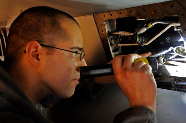 Staff Sgt. Scott Daugharty, 35th Maintenance Squadron inspection personnel, inspects an aircraft for foreign object damage at Misawa Air Base, Japan, April 25, 2013. The 35th Maintenance Group recently finished a Logistics Compliance Assessment Program inspection, which ensures squadrons are following proper Air Force standards and procedures. (U.S. Air Force photo by Airman 1st Class Kaleb Snay)