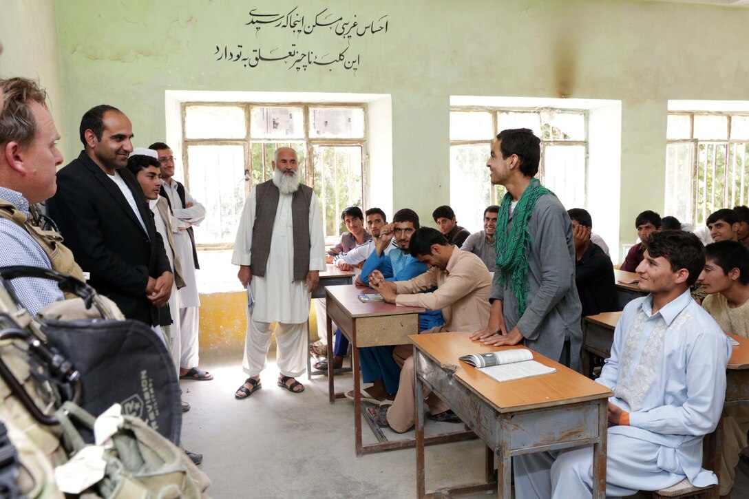 Members of Provincial Reconstruction Team Farah and Mohammed Saber, Farah provincial education director, first from left, listen as a student discusses his plans to become an engineer at Aboonaser Farahi high school in Farah City, Afghanistan, May 13, 2013. 