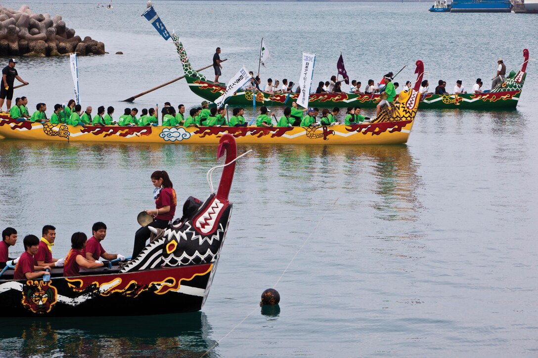 The single Marine program team paddles through the Naha New Port Wharf during the 39th annual Naha dragon boat race May 5. The SMP team began learning rowing fundamentals and techniques from members of the Japan Maritime Self-Defense Force’s explosive ordnance disposal team three months prior to the race. Photo By Cpl. Anthony Kirby
