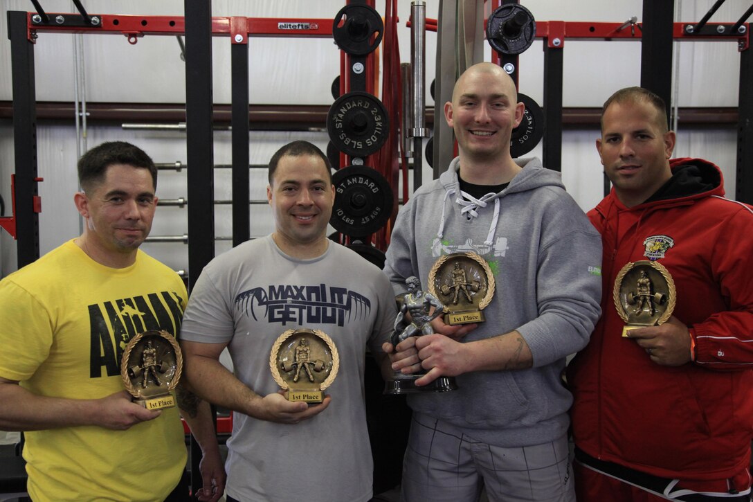 (From left to right) Staff Sgt Diego Corr (of the 2nd Marine Division), Sgt Thomas Geist, Staff Sgt Erik Hodge and Cpl Michael Politowicz display their trophies after competing in the Spring military challenge in Newport, N.C. March 28. MARSOC's Stone Bay Bar Benders competed in the powerlifting contest to help raise money for the Hope for the Warriors foundation, a charity that helps wounded warriors and their families. (U.S. Marine Corps photo by Sgt Kyle McNally/Released)