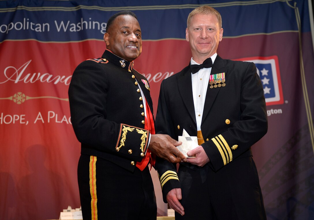 Lieutenant Commander Trevor Petrou receives a Special Salute Award from Lt. Gen. Willie Williams at a United Services Organization dinner in Arlington, Va. March 14. Petrou received the award on behalf of MARSOC and the Marine Corps for exceptional achievements and contributions to the military medical field.