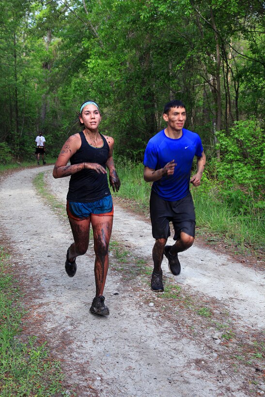 Participants of the infamous “Mud, Seat and Tears Run” sponsored by U.S. Marine Corps Forces, Special Operations Command, endure an intense trail filled with forest terrain, winding trails, fallen trees and giant mud pits April 27, 2013. The run consisted of a five-mile trek through the woods and muddy terrain of Stone Bay. 