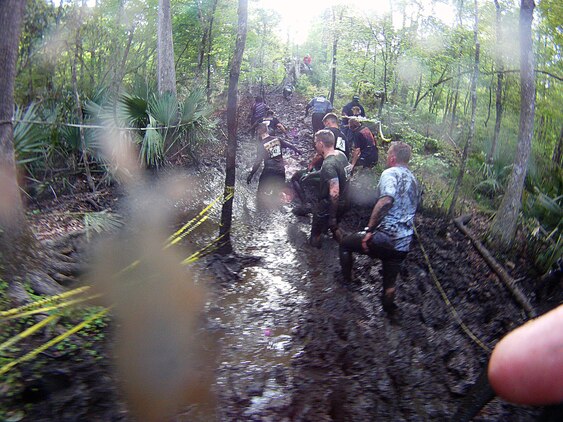 Participants of the infamous “Mud, Seat and Tears Run” sponsored by U.S. Marine Corps Forces, Special Operations Command, endure an intense trail filled with forest terrain, winding trails, fallen trees and giant mud pits April 27, 2013. The run consisted of a five-mile trek through the woods and muddy terrain of Stone Bay. 