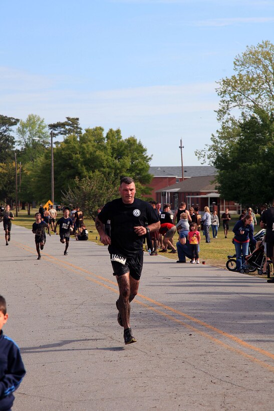 Participants of the infamous “Mud, Seat and Tears Run” sponsored by U.S. Marine Corps Forces, Special Operations Command, endure an intense trail filled with forest terrain, winding trails, fallen trees and giant mud pits April 27, 2013. The run consisted of a five-mile trek through the woods and muddy terrain of Stone Bay. 