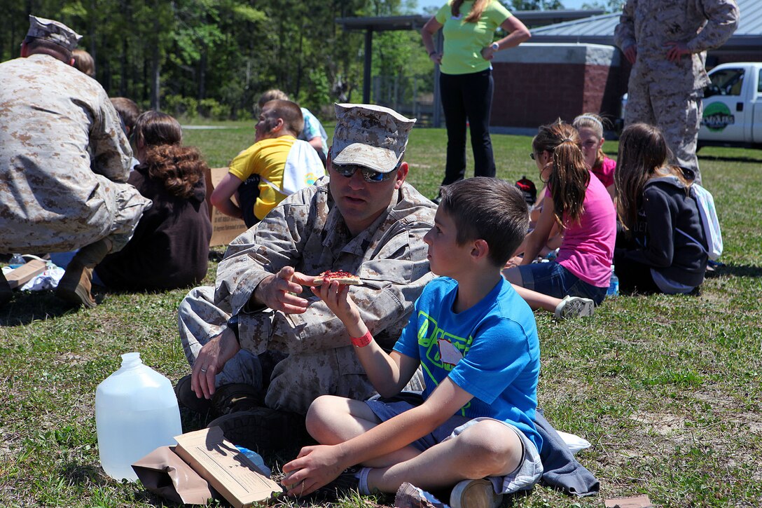 Marine spouses and children participate in a family day sponsored by U.S. Marine Corps Forces, Special Operations Command, April 26, 2013. The spouses shot live weapons, rappelled and were taught martial arts by Marine instructors. Children played games and did modified exercises during the event. Static displays showed MARSOC weapons and gear. After all the events the Marines and families had a barbecue.   