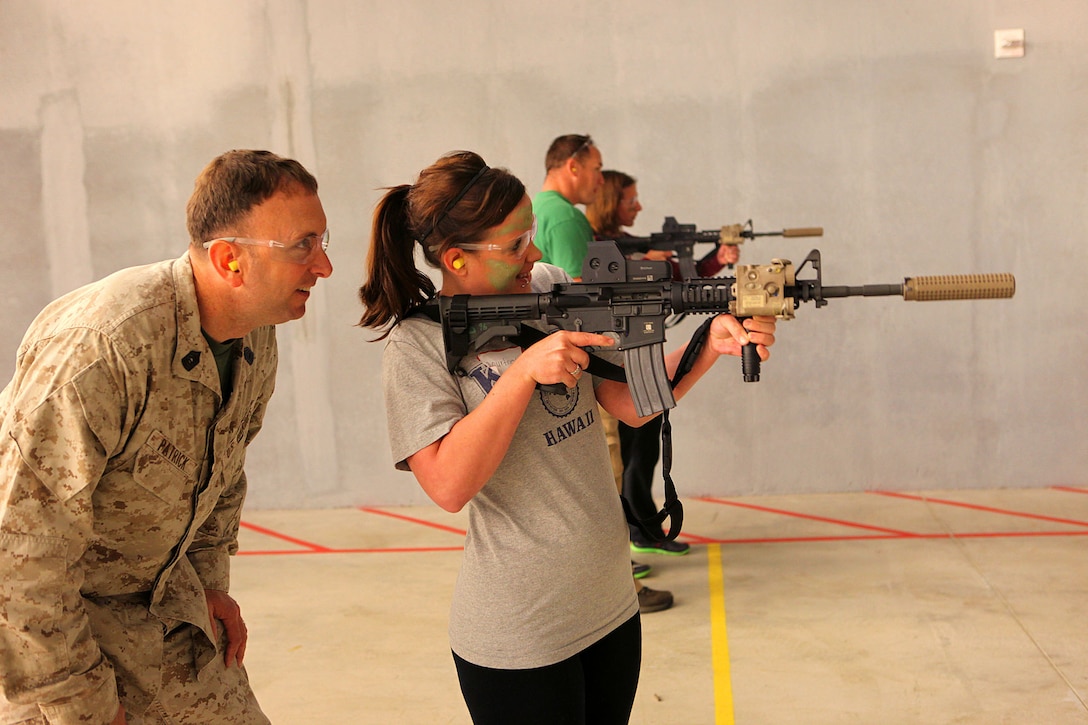 Marine spouses and children participate in a family day sponsored by U.S. Marine Corps Forces, Special Operations Command, April 26, 2013. The spouses shot live weapons, rappelled and were taught martial arts by Marine instructors. Children played games and did modified exercises during the event. Static displays showed MARSOC weapons and gear. After all the events the Marines and families had a barbecue.   