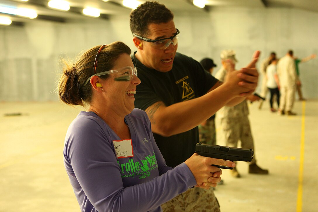 Marine spouses and children participate in a family day sponsored by U.S. Marine Corps Forces, Special Operations Command, April 26, 2013. The spouses shot live weapons, rappelled and were taught martial arts by Marine instructors. Children played games and did modified exercises during the event. Static displays showed MARSOC weapons and gear. After all the events the Marines and families had a barbecue.   