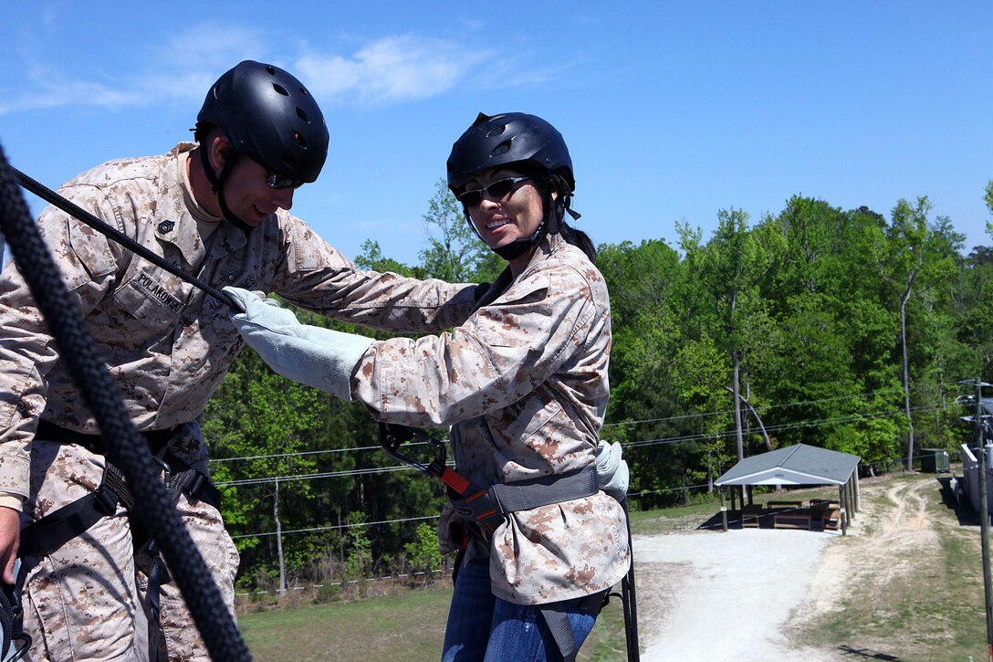 Marine spouses and children participate in a family day sponsored by U.S. Marine Corps Forces, Special Operations Command, April 26, 2013. The spouses shot live weapons, rappelled and were taught martial arts by Marine instructors. Children played games and did modified exercises during the event. Static displays showed MARSOC weapons and gear. After all the events the Marines and families had a barbecue.   